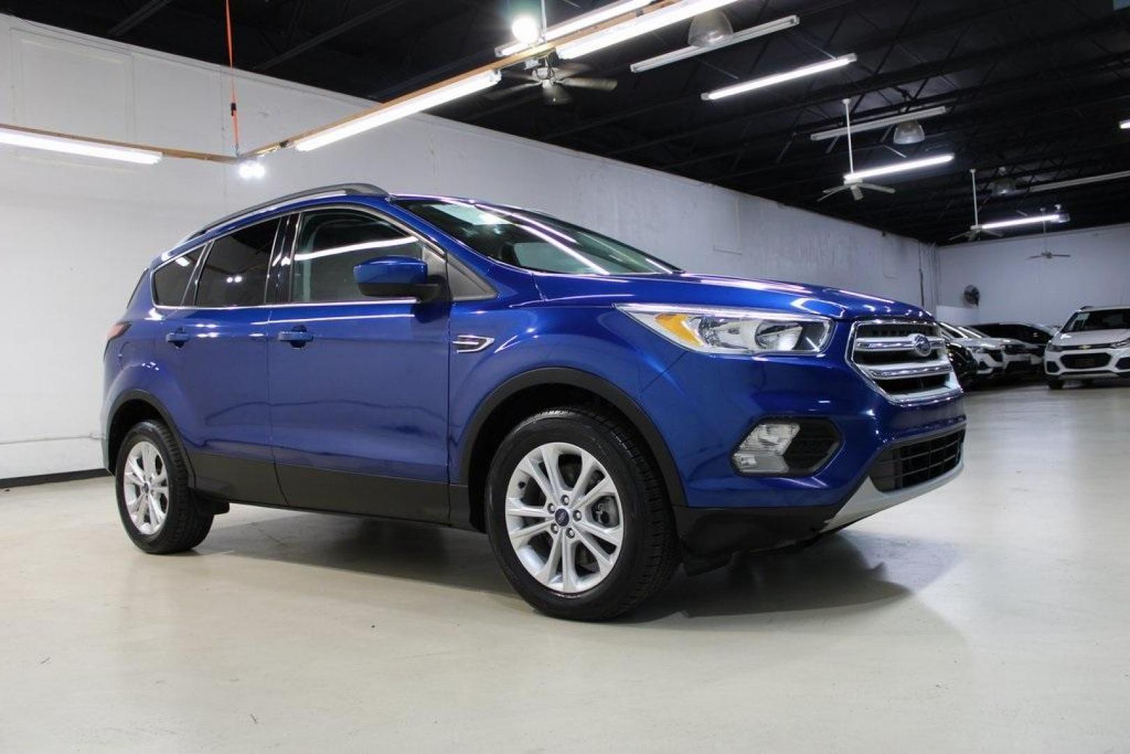 2018 Lightning Blue /Charcoal Black Ford Escape SE (1FMCU9GD6JU) with an EcoBoost 2.0L I4 GTDi DOHC Turbocharged VCT engine, Automatic transmission, located at 15300 Midway Rd., Addison, TX, 75001, (972) 702-0011, 32.958321, -96.838074 - 2018 Ford Escape SE<br>Now Available at Midway Auto Group Addison, Texas<br><br>Stylish, versatile, and packed with features, the 2018 Ford Escape SE offers a confident driving experience thats perfect for both urban commutes and weekend getaways. With its turbocharged performance, smart technology - Photo#6