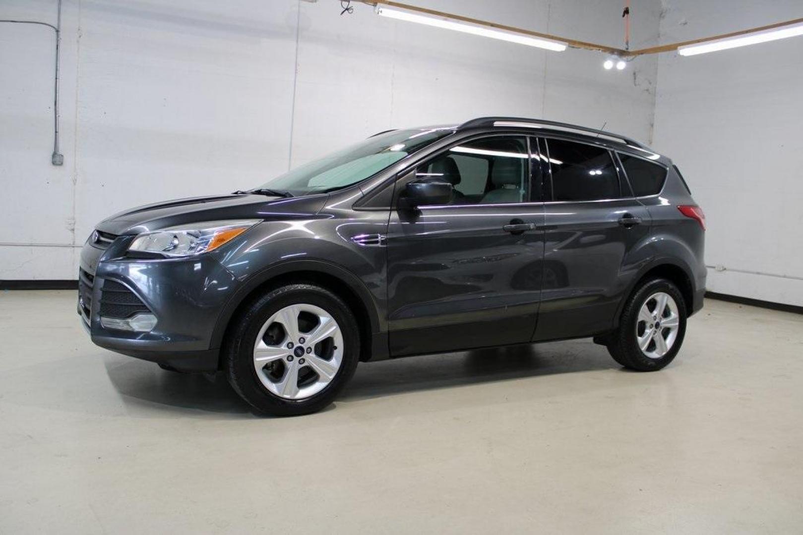 2015 Magnetic /Medium Light Stone Ford Escape SE (1FMCU0GXXFU) with an EcoBoost 1.6L I4 GTDi DOHC Turbocharged VCT engine, Automatic transmission, located at 15300 Midway Rd., Addison, TX, 75001, (972) 702-0011, 32.958321, -96.838074 - 2015 Ford Escape SE<br>Now Available at Midway Auto Group Addison, Texas<br><br>Sporty, practical, and fuel-efficient, the 2015 Ford Escape SE offers everything you want in a compact SUVresponsive handling, flexible cargo space, and modern technology. Whether you're navigating daily errands in Addi - Photo#4