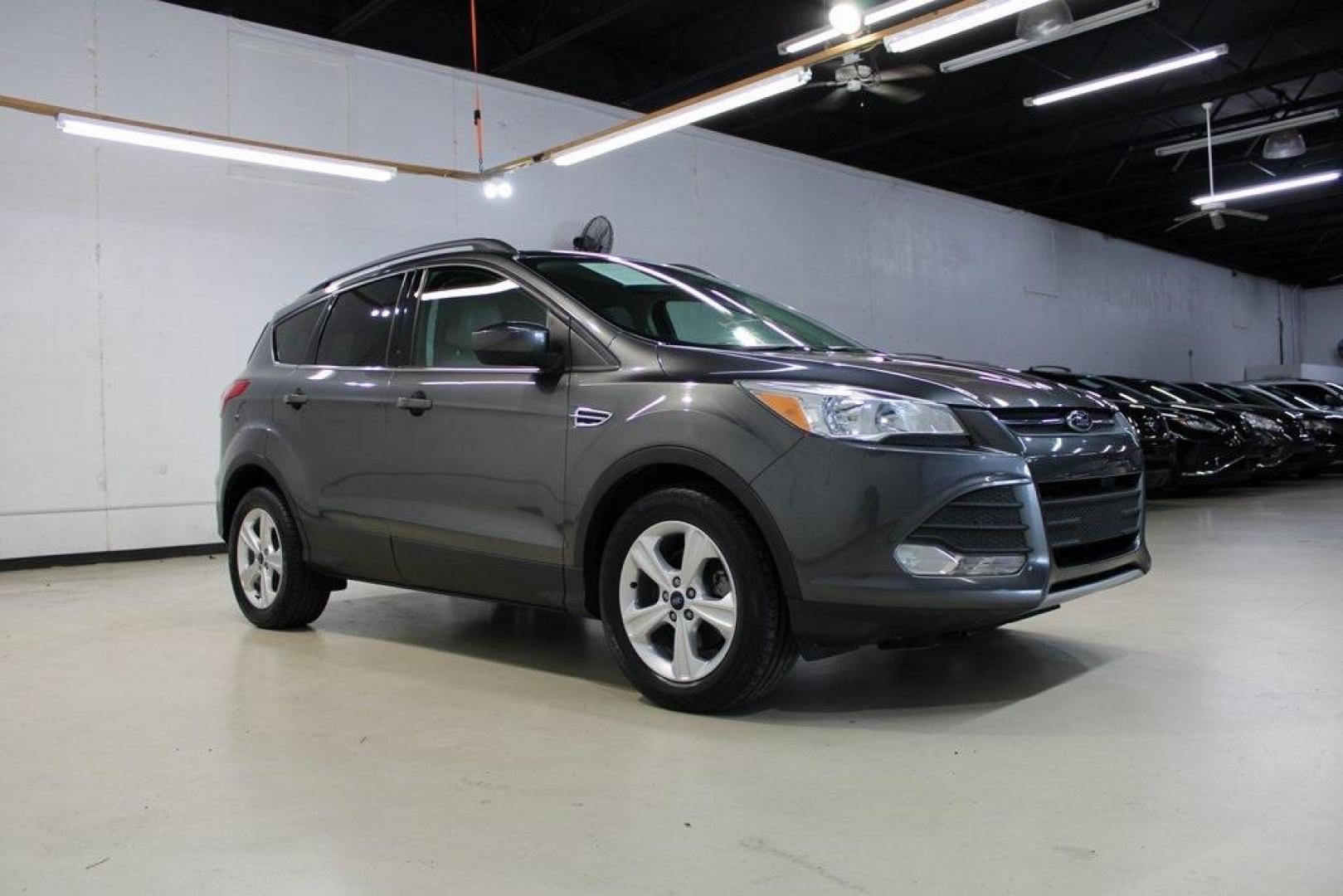 2015 Magnetic /Medium Light Stone Ford Escape SE (1FMCU0GXXFU) with an EcoBoost 1.6L I4 GTDi DOHC Turbocharged VCT engine, Automatic transmission, located at 15300 Midway Rd., Addison, TX, 75001, (972) 702-0011, 32.958321, -96.838074 - 2015 Ford Escape SE<br>Now Available at Midway Auto Group Addison, Texas<br><br>Sporty, practical, and fuel-efficient, the 2015 Ford Escape SE offers everything you want in a compact SUVresponsive handling, flexible cargo space, and modern technology. Whether you're navigating daily errands in Addi - Photo#6