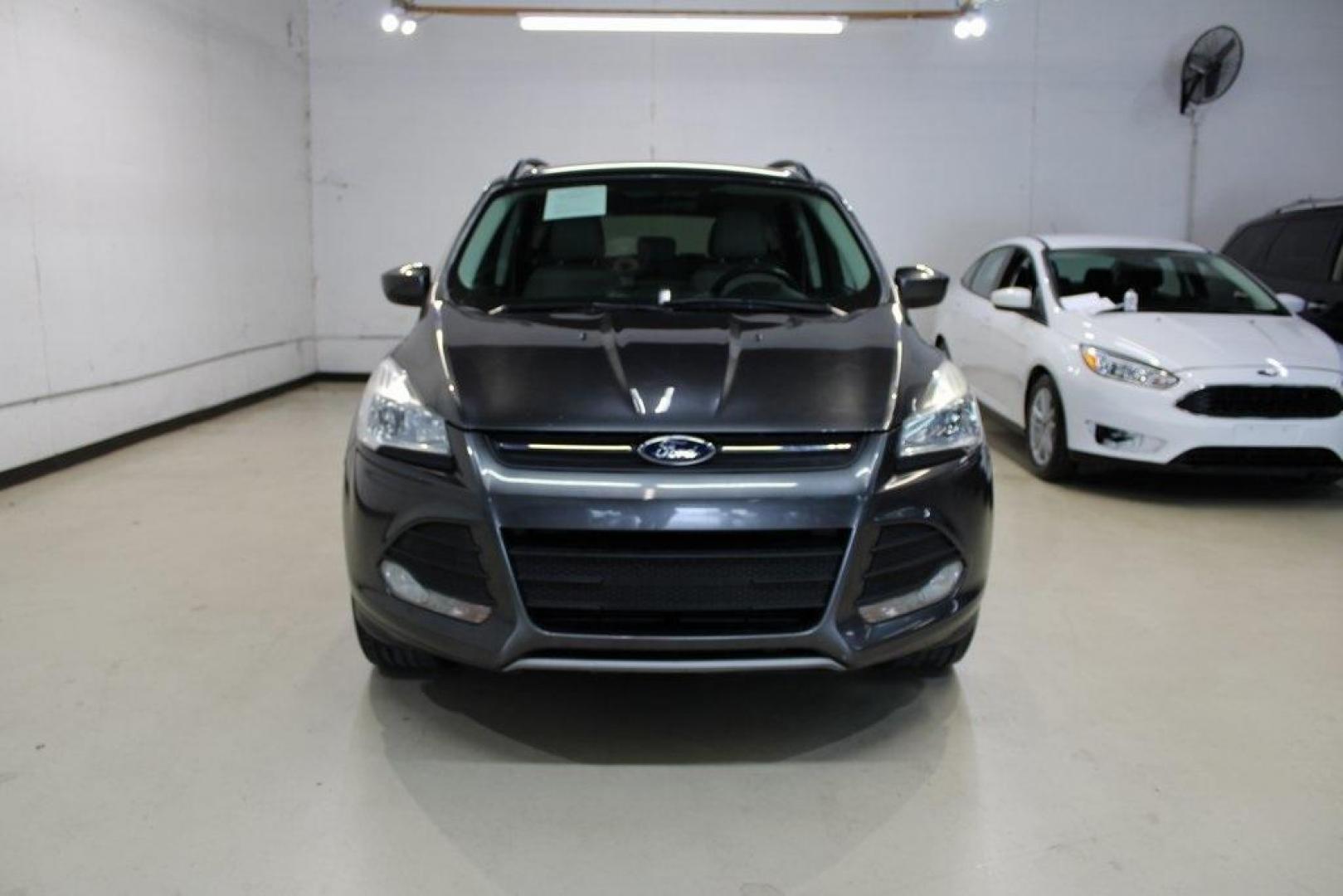 2015 Magnetic /Medium Light Stone Ford Escape SE (1FMCU0GXXFU) with an EcoBoost 1.6L I4 GTDi DOHC Turbocharged VCT engine, Automatic transmission, located at 15300 Midway Rd., Addison, TX, 75001, (972) 702-0011, 32.958321, -96.838074 - 2015 Ford Escape SE<br>Now Available at Midway Auto Group Addison, Texas<br><br>Sporty, practical, and fuel-efficient, the 2015 Ford Escape SE offers everything you want in a compact SUVresponsive handling, flexible cargo space, and modern technology. Whether you're navigating daily errands in Addi - Photo#7