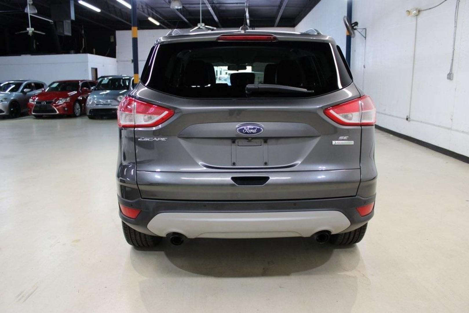 2015 Magnetic /Medium Light Stone Ford Escape SE (1FMCU0GXXFU) with an EcoBoost 1.6L I4 GTDi DOHC Turbocharged VCT engine, Automatic transmission, located at 15300 Midway Rd., Addison, TX, 75001, (972) 702-0011, 32.958321, -96.838074 - 2015 Ford Escape SE<br>Now Available at Midway Auto Group Addison, Texas<br><br>Sporty, practical, and fuel-efficient, the 2015 Ford Escape SE offers everything you want in a compact SUVresponsive handling, flexible cargo space, and modern technology. Whether you're navigating daily errands in Addi - Photo#8