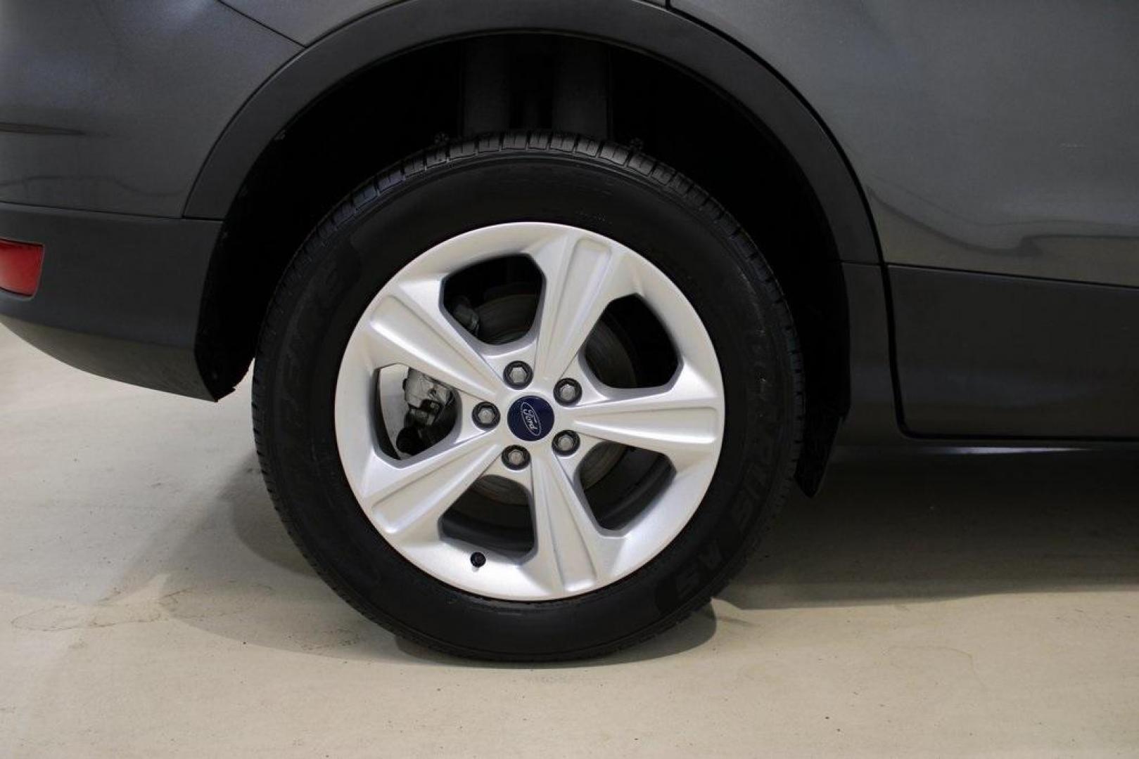 2015 Magnetic /Medium Light Stone Ford Escape SE (1FMCU0GXXFU) with an EcoBoost 1.6L I4 GTDi DOHC Turbocharged VCT engine, Automatic transmission, located at 15300 Midway Rd., Addison, TX, 75001, (972) 702-0011, 32.958321, -96.838074 - 2015 Ford Escape SE<br>Now Available at Midway Auto Group Addison, Texas<br><br>Sporty, practical, and fuel-efficient, the 2015 Ford Escape SE offers everything you want in a compact SUVresponsive handling, flexible cargo space, and modern technology. Whether you're navigating daily errands in Addi - Photo#11