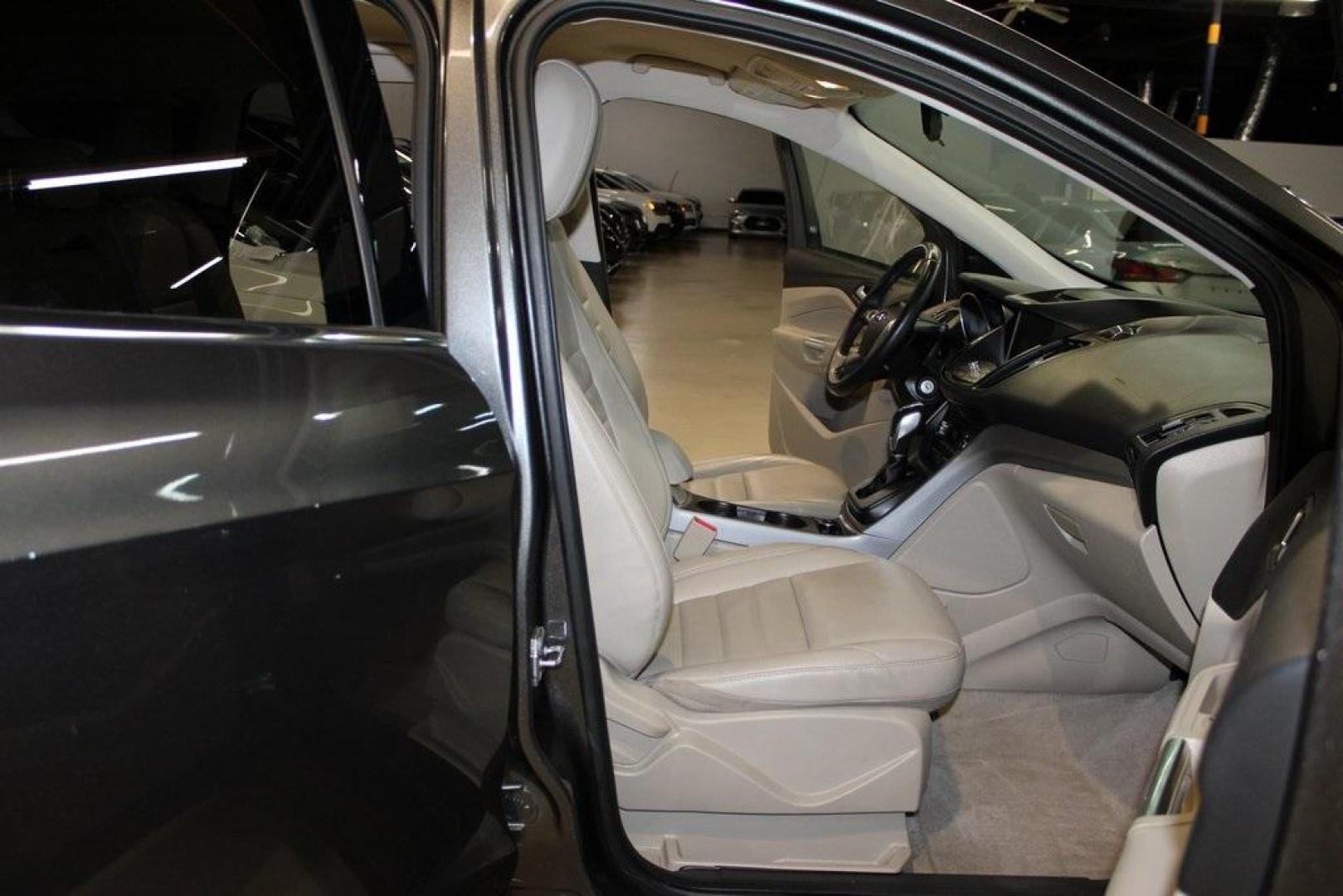 2015 Magnetic /Medium Light Stone Ford Escape SE (1FMCU0GXXFU) with an EcoBoost 1.6L I4 GTDi DOHC Turbocharged VCT engine, Automatic transmission, located at 15300 Midway Rd., Addison, TX, 75001, (972) 702-0011, 32.958321, -96.838074 - 2015 Ford Escape SE<br>Now Available at Midway Auto Group Addison, Texas<br><br>Sporty, practical, and fuel-efficient, the 2015 Ford Escape SE offers everything you want in a compact SUVresponsive handling, flexible cargo space, and modern technology. Whether you're navigating daily errands in Addi - Photo#15