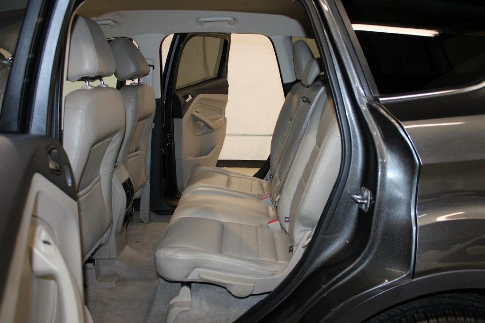 2015 Magnetic /Medium Light Stone Ford Escape SE (1FMCU0GXXFU) with an EcoBoost 1.6L I4 GTDi DOHC Turbocharged VCT engine, Automatic transmission, located at 15300 Midway Rd., Addison, TX, 75001, (972) 702-0011, 32.958321, -96.838074 - 2015 Ford Escape SE<br>Now Available at Midway Auto Group Addison, Texas<br><br>Sporty, practical, and fuel-efficient, the 2015 Ford Escape SE offers everything you want in a compact SUVresponsive handling, flexible cargo space, and modern technology. Whether you're navigating daily errands in Addi - Photo#17