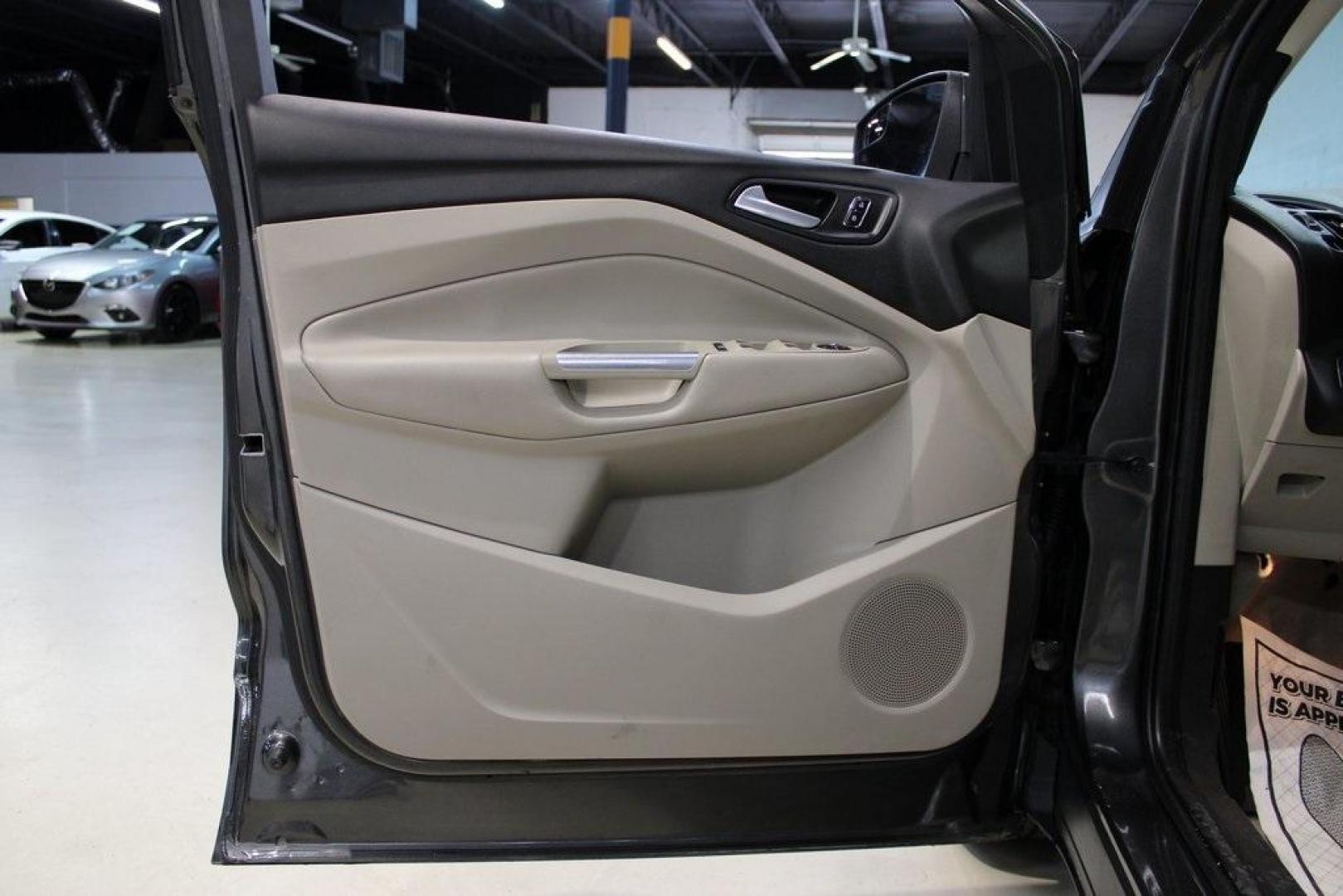 2015 Magnetic /Medium Light Stone Ford Escape SE (1FMCU0GXXFU) with an EcoBoost 1.6L I4 GTDi DOHC Turbocharged VCT engine, Automatic transmission, located at 15300 Midway Rd., Addison, TX, 75001, (972) 702-0011, 32.958321, -96.838074 - 2015 Ford Escape SE<br>Now Available at Midway Auto Group Addison, Texas<br><br>Sporty, practical, and fuel-efficient, the 2015 Ford Escape SE offers everything you want in a compact SUVresponsive handling, flexible cargo space, and modern technology. Whether you're navigating daily errands in Addi - Photo#27