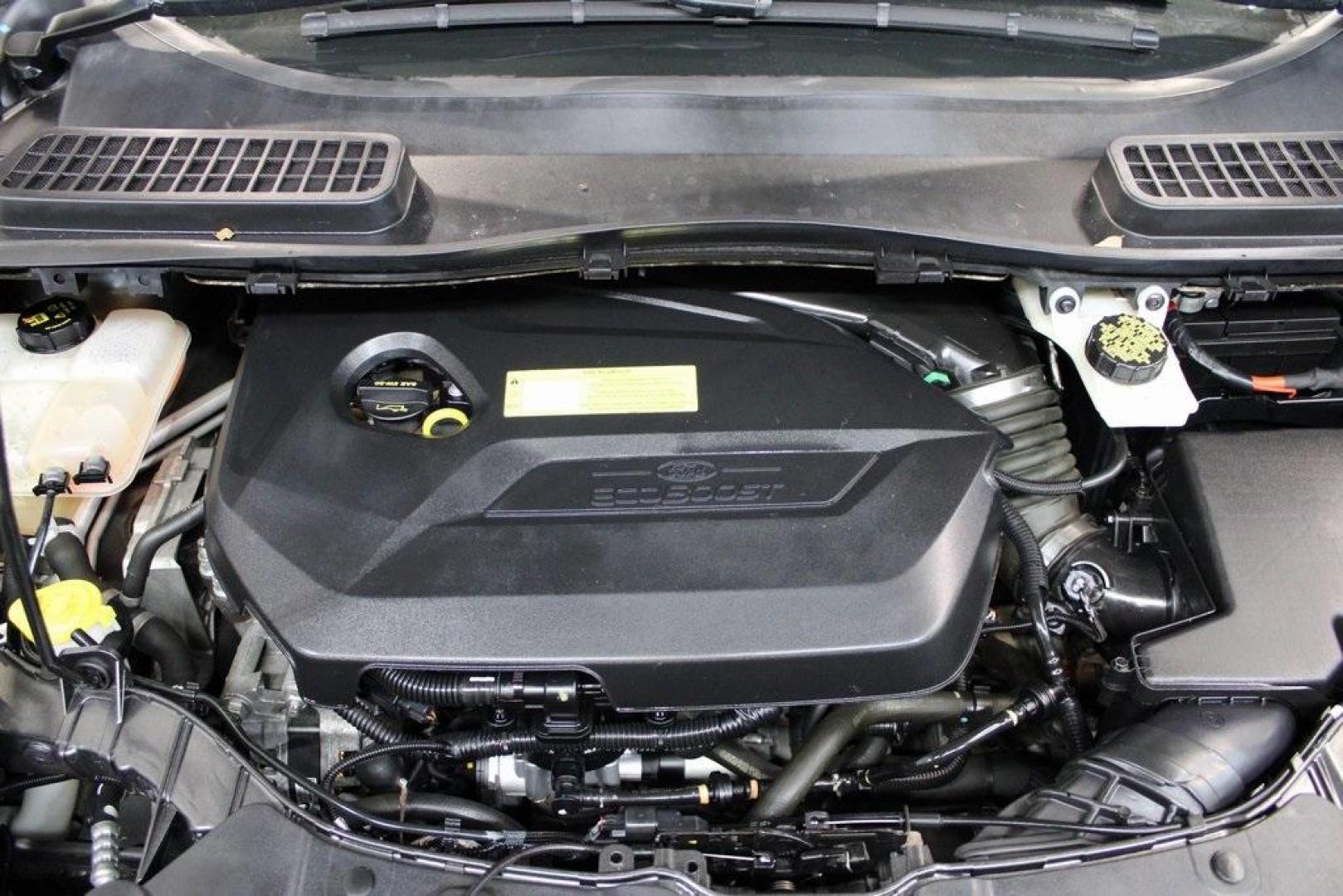 2015 Magnetic /Medium Light Stone Ford Escape SE (1FMCU0GXXFU) with an EcoBoost 1.6L I4 GTDi DOHC Turbocharged VCT engine, Automatic transmission, located at 15300 Midway Rd., Addison, TX, 75001, (972) 702-0011, 32.958321, -96.838074 - 2015 Ford Escape SE<br>Now Available at Midway Auto Group Addison, Texas<br><br>Sporty, practical, and fuel-efficient, the 2015 Ford Escape SE offers everything you want in a compact SUVresponsive handling, flexible cargo space, and modern technology. Whether you're navigating daily errands in Addi - Photo#29
