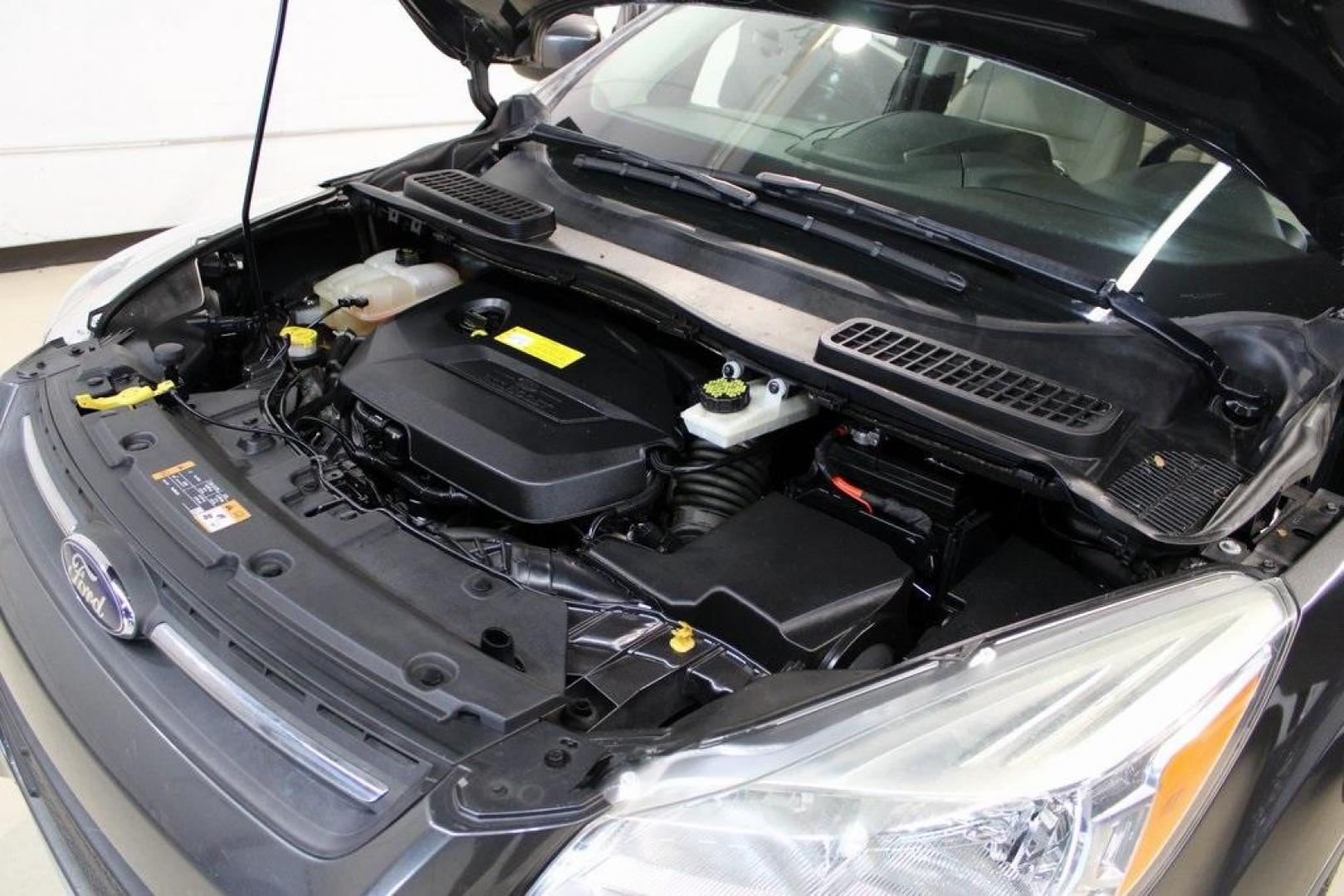 2015 Magnetic /Medium Light Stone Ford Escape SE (1FMCU0GXXFU) with an EcoBoost 1.6L I4 GTDi DOHC Turbocharged VCT engine, Automatic transmission, located at 15300 Midway Rd., Addison, TX, 75001, (972) 702-0011, 32.958321, -96.838074 - 2015 Ford Escape SE<br>Now Available at Midway Auto Group Addison, Texas<br><br>Sporty, practical, and fuel-efficient, the 2015 Ford Escape SE offers everything you want in a compact SUVresponsive handling, flexible cargo space, and modern technology. Whether you're navigating daily errands in Addi - Photo#30