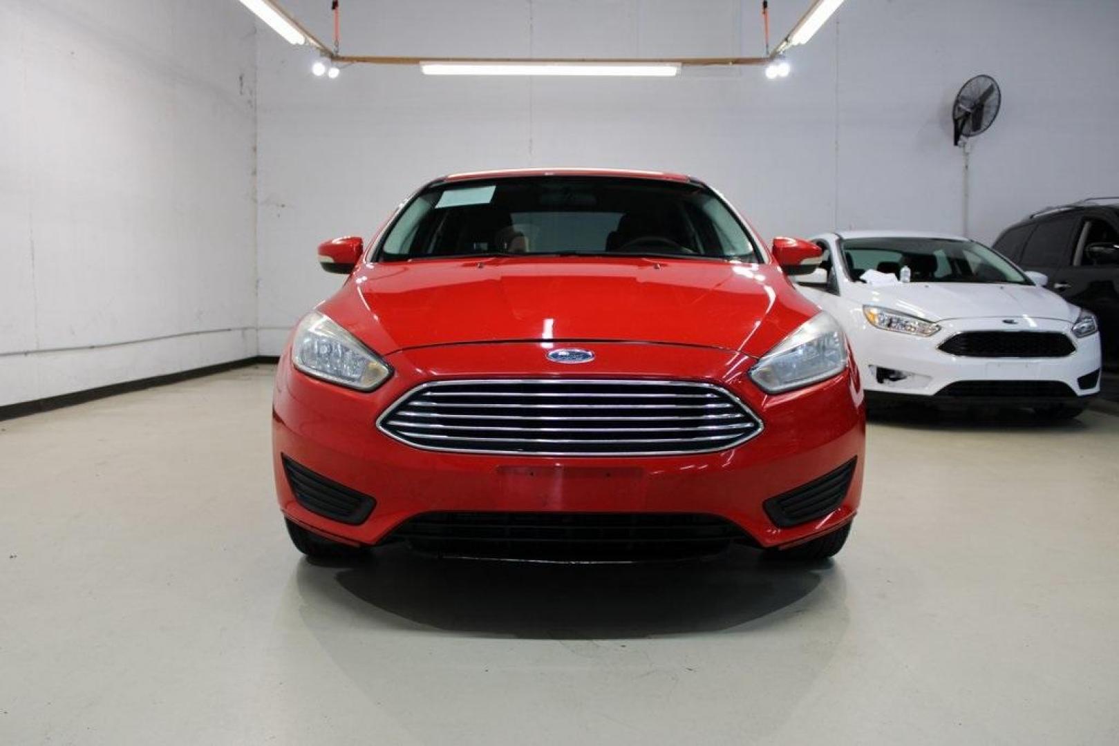 2017 Race Red /Charcoal Black Ford Focus SE (1FADP3F23HL) with an 2.0L 4-Cylinder DGI Flex Fuel Turbocharged DOHC engine, Automatic transmission, located at 15300 Midway Rd., Addison, TX, 75001, (972) 702-0011, 32.958321, -96.838074 - ''2017 Ford Focus SE<br>Now Available at Midway Auto Group Addison, Texas<br><br>Affordable, efficient, and well-equipped, the 2017 Ford Focus SE is a smart choice for anyone looking for a reliable compact sedan with style and substance. Whether you're commuting through Addison or cruising the open - Photo#5