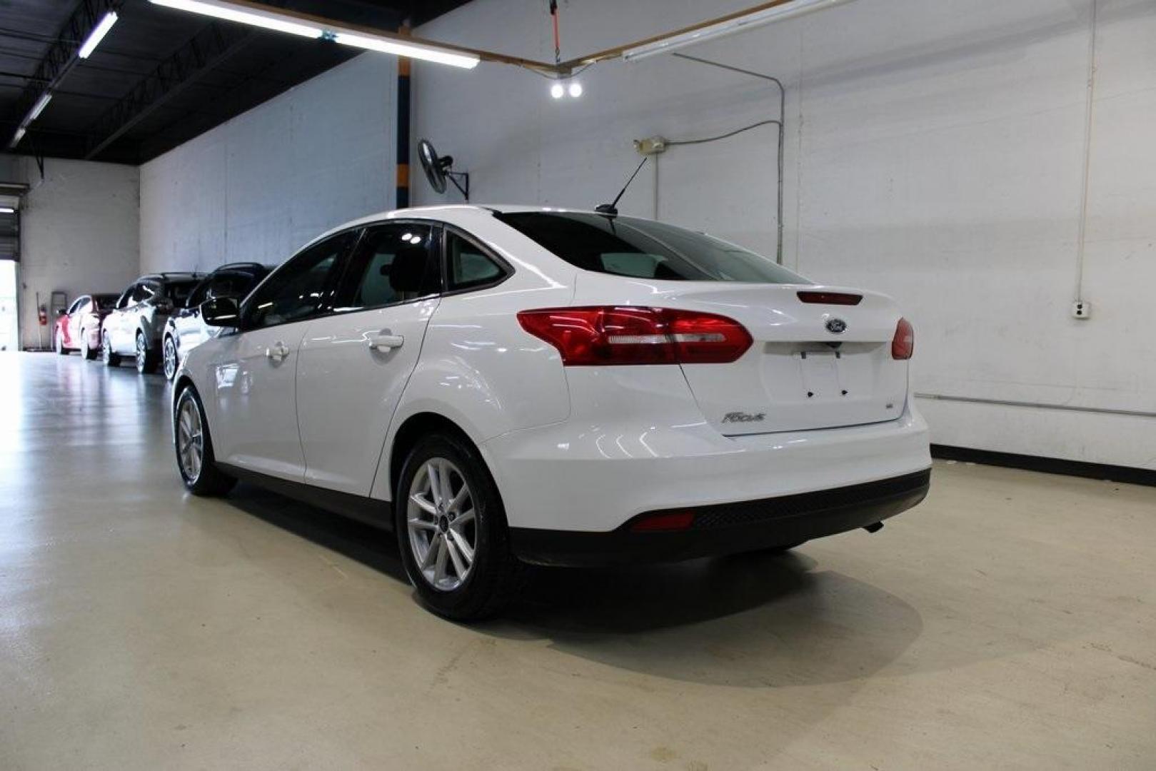 2018 Oxford White /Charcoal Black Ford Focus SE (1FADP3F29JL) with an 2.0L I4 DGI Ti-VCT engine, Automatic transmission, located at 15300 Midway Rd., Addison, TX, 75001, (972) 702-0011, 32.958321, -96.838074 - 2018 Ford Focus SE<br>Now Available at Midway Auto Group Addison, Texas<br><br>Compact, efficient, and packed with value, the 2018 Ford Focus SE offers a smart balance of fuel economy, comfort, and modern features. Whether you're commuting through Addison or navigating city streets across the DFW m - Photo#2