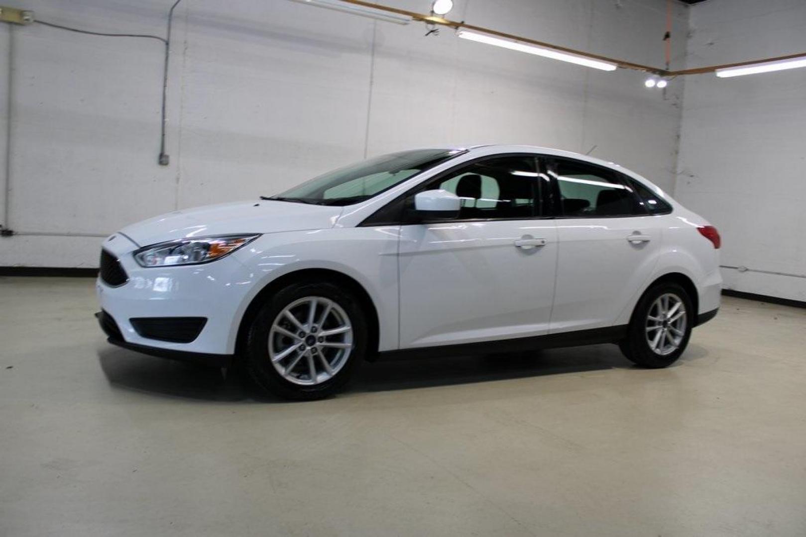 2018 Oxford White /Charcoal Black Ford Focus SE (1FADP3F29JL) with an 2.0L I4 DGI Ti-VCT engine, Automatic transmission, located at 15300 Midway Rd., Addison, TX, 75001, (972) 702-0011, 32.958321, -96.838074 - 2018 Ford Focus SE<br>Now Available at Midway Auto Group Addison, Texas<br><br>Compact, efficient, and packed with value, the 2018 Ford Focus SE offers a smart balance of fuel economy, comfort, and modern features. Whether you're commuting through Addison or navigating city streets across the DFW m - Photo#3