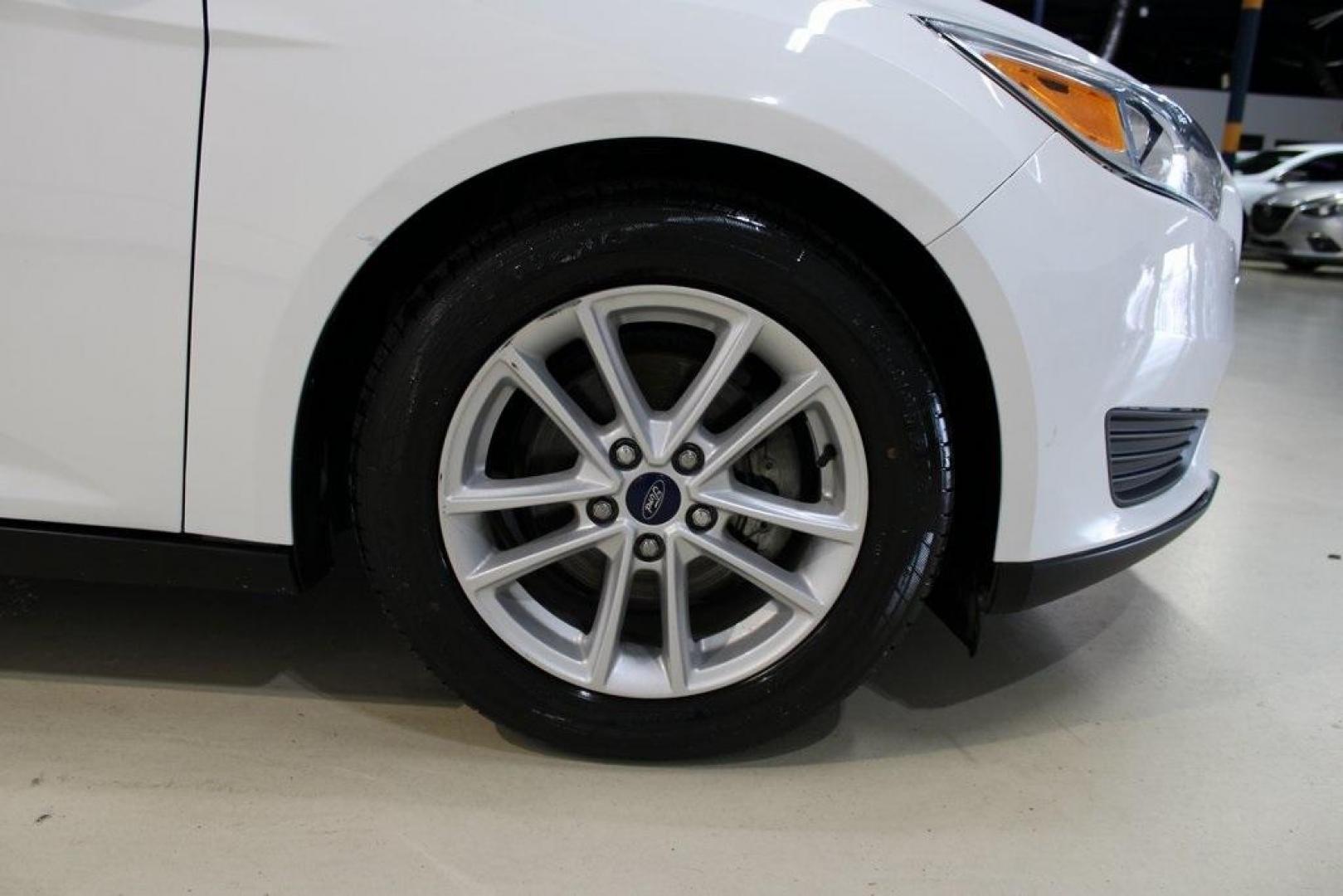 2018 Oxford White /Charcoal Black Ford Focus SE (1FADP3F29JL) with an 2.0L I4 DGI Ti-VCT engine, Automatic transmission, located at 15300 Midway Rd., Addison, TX, 75001, (972) 702-0011, 32.958321, -96.838074 - 2018 Ford Focus SE<br>Now Available at Midway Auto Group Addison, Texas<br><br>Compact, efficient, and packed with value, the 2018 Ford Focus SE offers a smart balance of fuel economy, comfort, and modern features. Whether you're commuting through Addison or navigating city streets across the DFW m - Photo#10