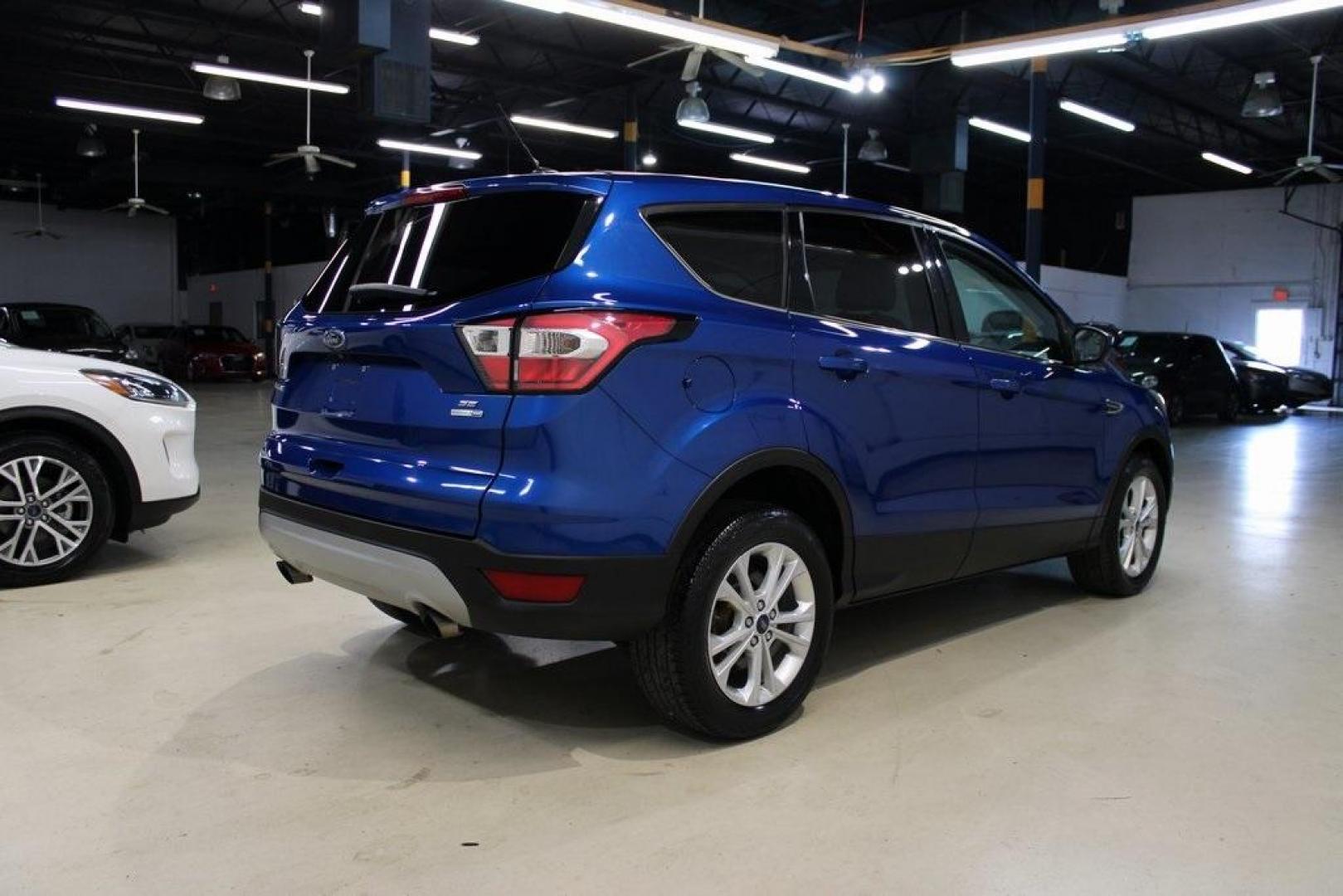 2017 Lightning Blue Metallic /Black Ford Escape SE (1FMCU9GD2HU) with an 1.5L EcoBoost engine, Automatic transmission, located at 15300 Midway Rd., Addison, TX, 75001, (972) 702-0011, 32.958321, -96.838074 - Photo#3