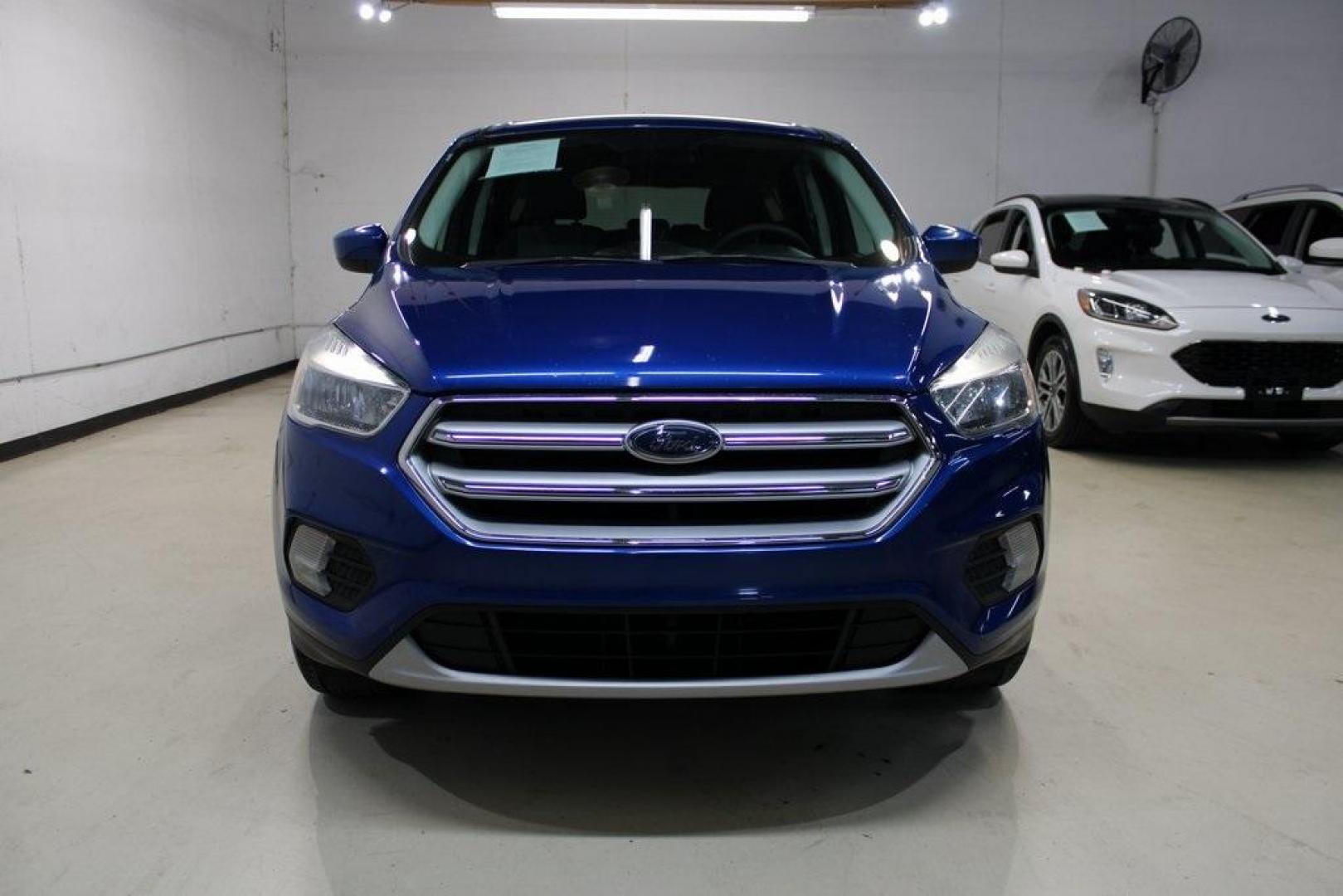 2017 Lightning Blue Metallic /Black Ford Escape SE (1FMCU9GD2HU) with an 1.5L EcoBoost engine, Automatic transmission, located at 15300 Midway Rd., Addison, TX, 75001, (972) 702-0011, 32.958321, -96.838074 - Photo#6