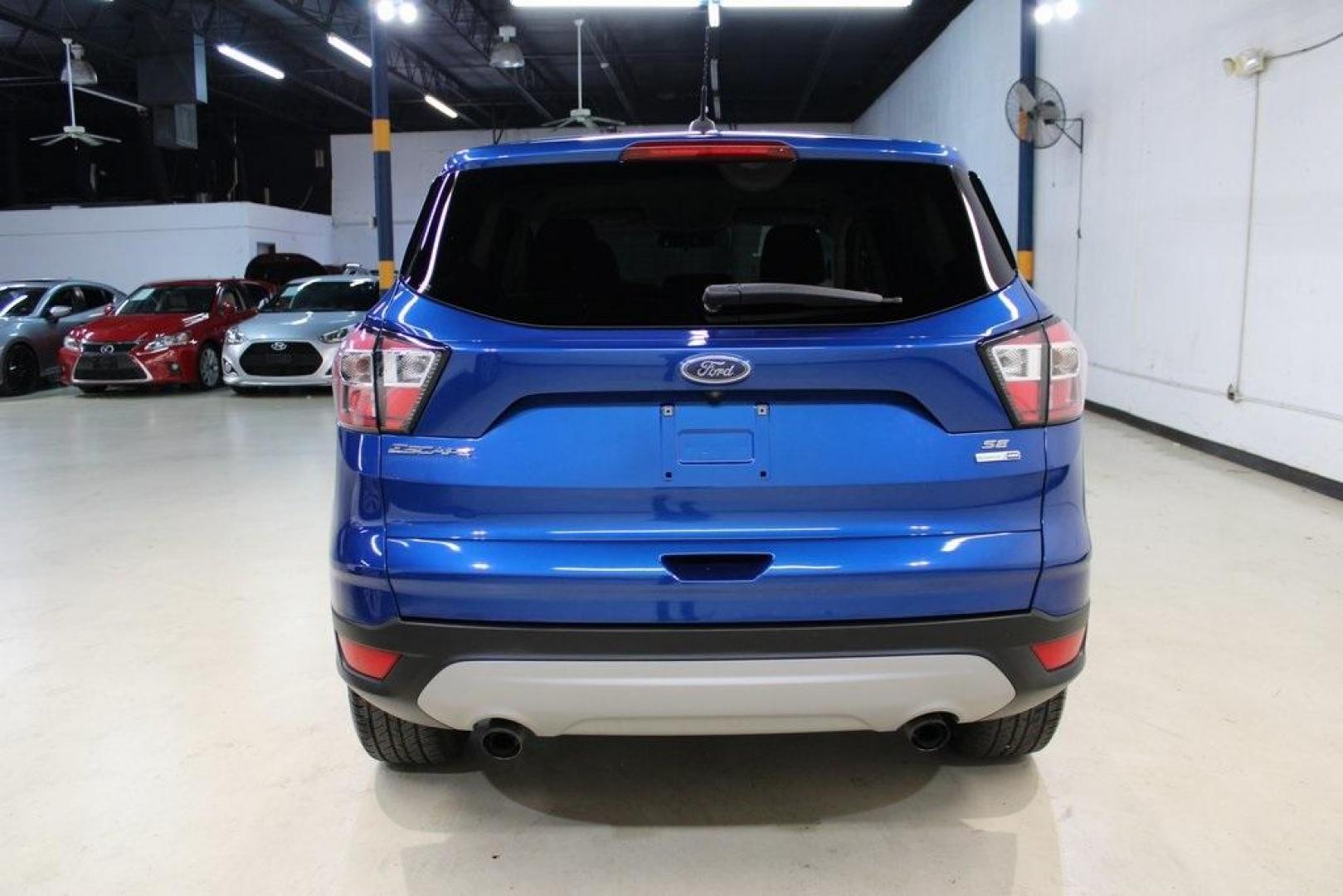 2017 Lightning Blue Metallic /Black Ford Escape SE (1FMCU9GD2HU) with an 1.5L EcoBoost engine, Automatic transmission, located at 15300 Midway Rd., Addison, TX, 75001, (972) 702-0011, 32.958321, -96.838074 - Photo#8