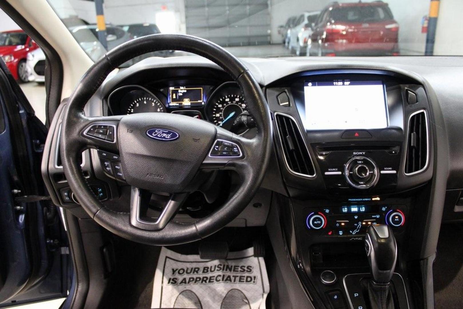 2018 Blue Metallic /Charcoal Black Ford Focus Titanium (1FADP3N28JL) with an 2.0L I4 DGI Ti-VCT engine, Automatic transmission, located at 15300 Midway Rd., Addison, TX, 75001, (972) 702-0011, 32.958321, -96.838074 - Photo#17