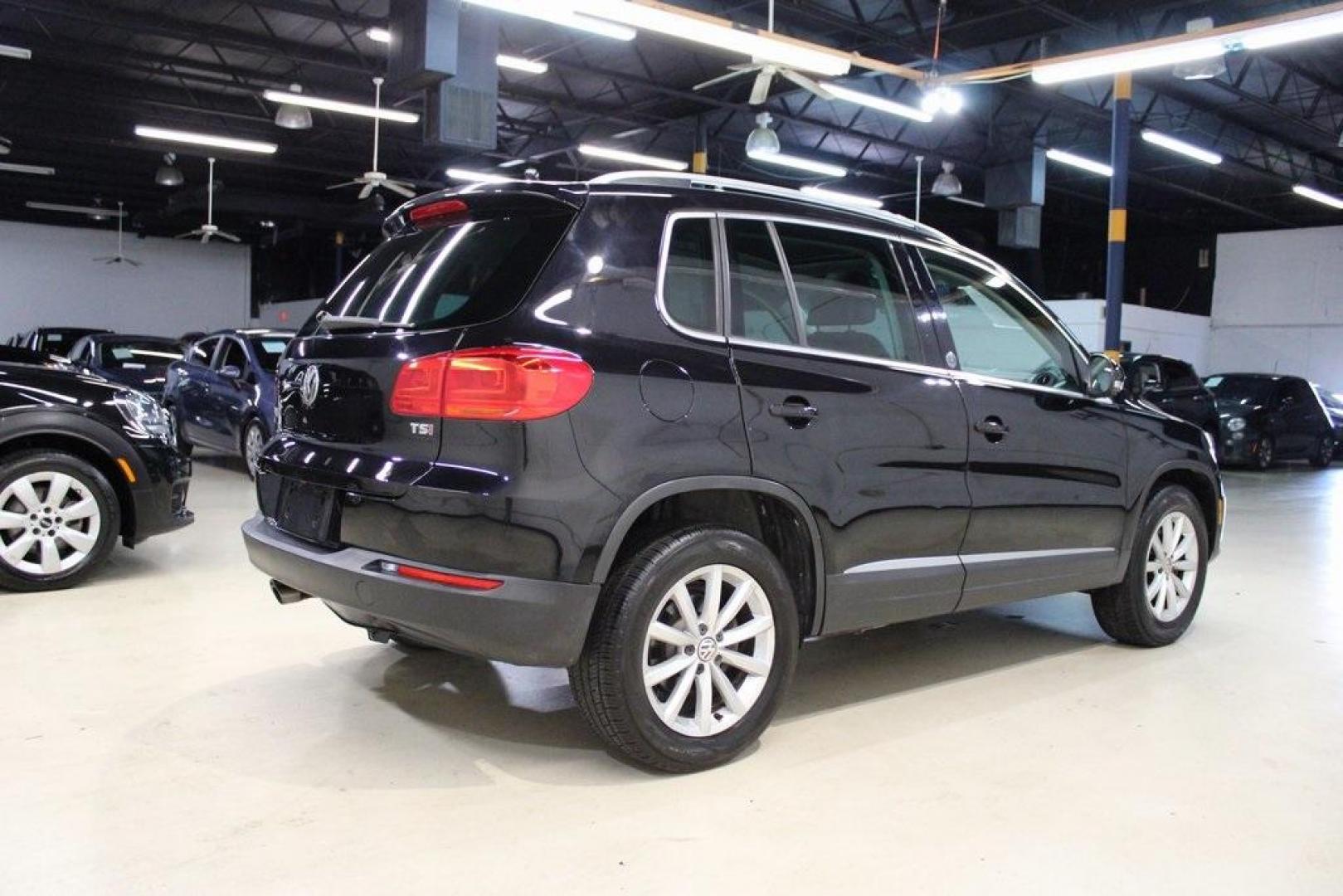 2017 Deep Black /Charcoal Black Volkswagen Tiguan 2.0T Wolfsburg Edition (WVGRV7AX4HK) with an 2.0L TSI DOHC engine, Automatic transmission, located at 15300 Midway Rd., Addison, TX, 75001, (972) 702-0011, 32.958321, -96.838074 - 2017 Volkswagen Touareg V6 Wolfsburg Edition<br>Now Available at Midway Auto Group Addison, Texas<br><br>Premium, powerful, and well-equipped, the 2017 Volkswagen Touareg Wolfsburg Edition delivers luxury SUV refinement with German-engineered performance. With a smooth V6 engine, a richly appointed - Photo#2