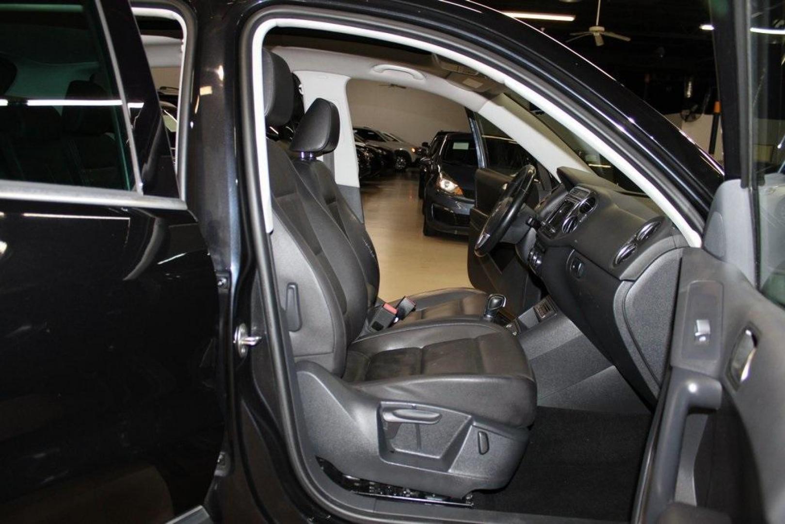 2017 Deep Black /Charcoal Black Volkswagen Tiguan 2.0T Wolfsburg Edition (WVGRV7AX4HK) with an 2.0L TSI DOHC engine, Automatic transmission, located at 15300 Midway Rd., Addison, TX, 75001, (972) 702-0011, 32.958321, -96.838074 - 2017 Volkswagen Touareg V6 Wolfsburg Edition<br>Now Available at Midway Auto Group Addison, Texas<br><br>Premium, powerful, and well-equipped, the 2017 Volkswagen Touareg Wolfsburg Edition delivers luxury SUV refinement with German-engineered performance. With a smooth V6 engine, a richly appointed - Photo#14