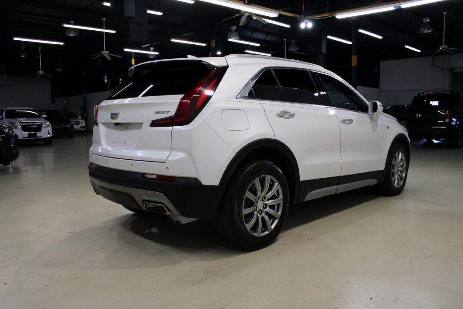 2021 Crystal White Tricoat /Black Cadillac XT4 Premium Luxury (1GYFZCR48MF) with an 2.0L I4 Turbocharged engine, Automatic transmission, located at 15300 Midway Rd., Addison, TX, 75001, (972) 702-0011, 32.958321, -96.838074 - 2021 Cadillac XT4 Premium Luxury<br>Now Available at Midway Auto Group Addison, Texas<br><br>Elevate your everyday drive with the 2021 Cadillac XT4 Premium Luxury a compact luxury SUV that blends bold styling, advanced technology, and premium comfort. With responsive performance and a refined inter - Photo#2