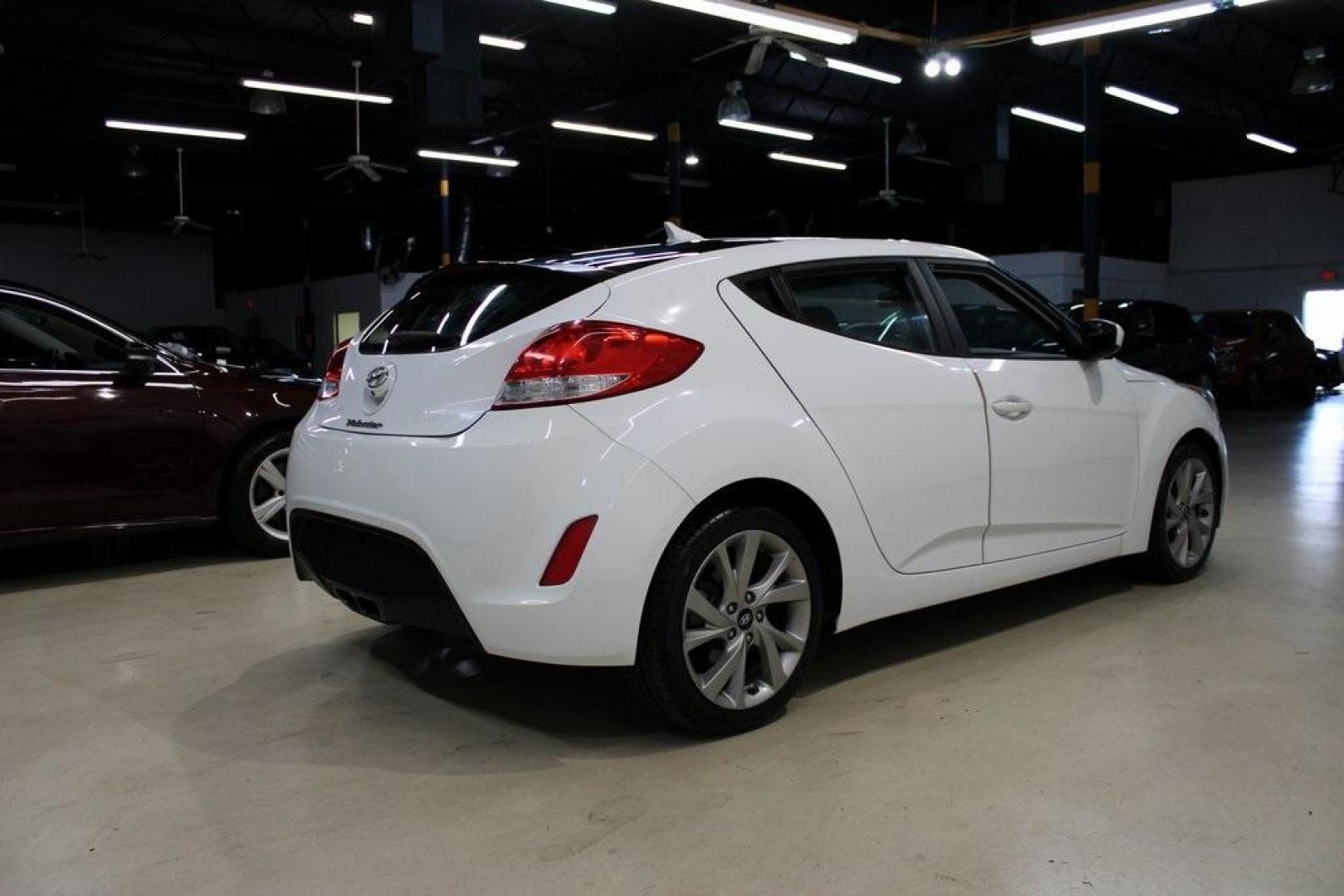 2016 Century White /Black Hyundai Veloster Base (KMHTC6AD4GU) with an 1.6L I4 DGI DOHC 16V ULEV II 132hp engine, Automatic transmission, located at 15300 Midway Rd., Addison, TX, 75001, (972) 702-0011, 32.958321, -96.838074 - 2016 Hyundai Veloster Base<br>Now Available at Midway Auto Group Addison, Texas<br><br>Sporty, efficient, and full of character, this 2016 Hyundai Veloster Base brings compact utility and fun-factor together seamlessly. With its distinctive 3-door hatchback design, confident performance, and modern - Photo#2