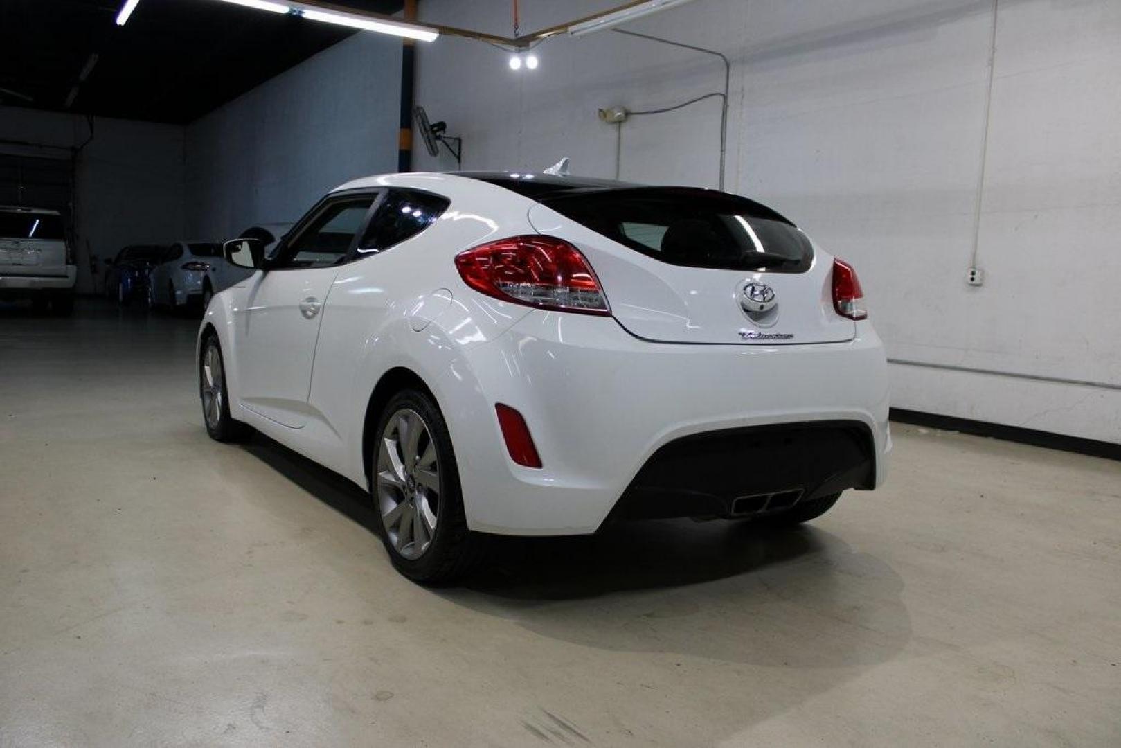 2016 Century White /Black Hyundai Veloster Base (KMHTC6AD4GU) with an 1.6L I4 DGI DOHC 16V ULEV II 132hp engine, Automatic transmission, located at 15300 Midway Rd., Addison, TX, 75001, (972) 702-0011, 32.958321, -96.838074 - 2016 Hyundai Veloster Base<br>Now Available at Midway Auto Group Addison, Texas<br><br>Sporty, efficient, and full of character, this 2016 Hyundai Veloster Base brings compact utility and fun-factor together seamlessly. With its distinctive 3-door hatchback design, confident performance, and modern - Photo#3