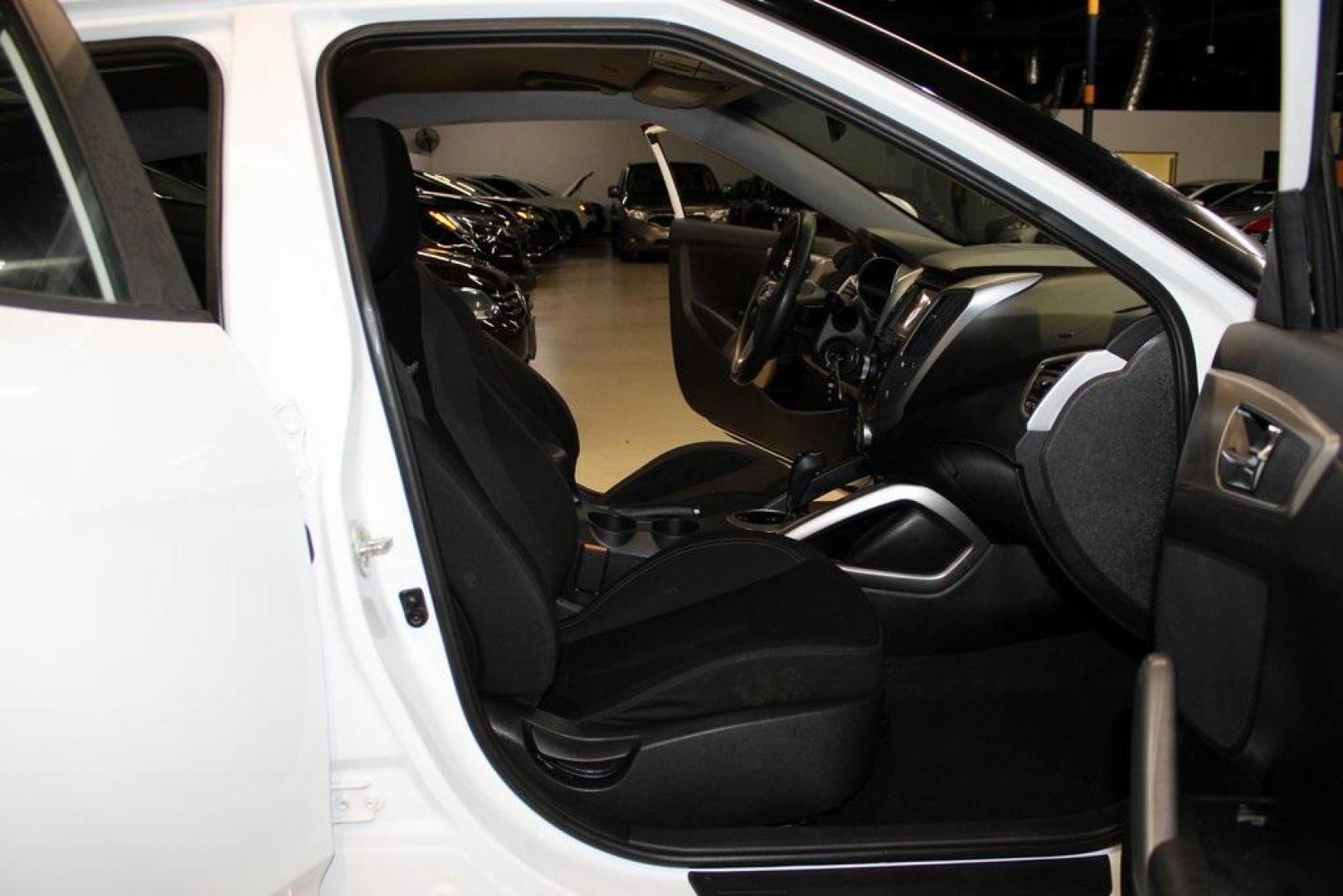 2016 Century White /Black Hyundai Veloster Base (KMHTC6AD4GU) with an 1.6L I4 DGI DOHC 16V ULEV II 132hp engine, Automatic transmission, located at 15300 Midway Rd., Addison, TX, 75001, (972) 702-0011, 32.958321, -96.838074 - 2016 Hyundai Veloster Base<br>Now Available at Midway Auto Group Addison, Texas<br><br>Sporty, efficient, and full of character, this 2016 Hyundai Veloster Base brings compact utility and fun-factor together seamlessly. With its distinctive 3-door hatchback design, confident performance, and modern - Photo#13