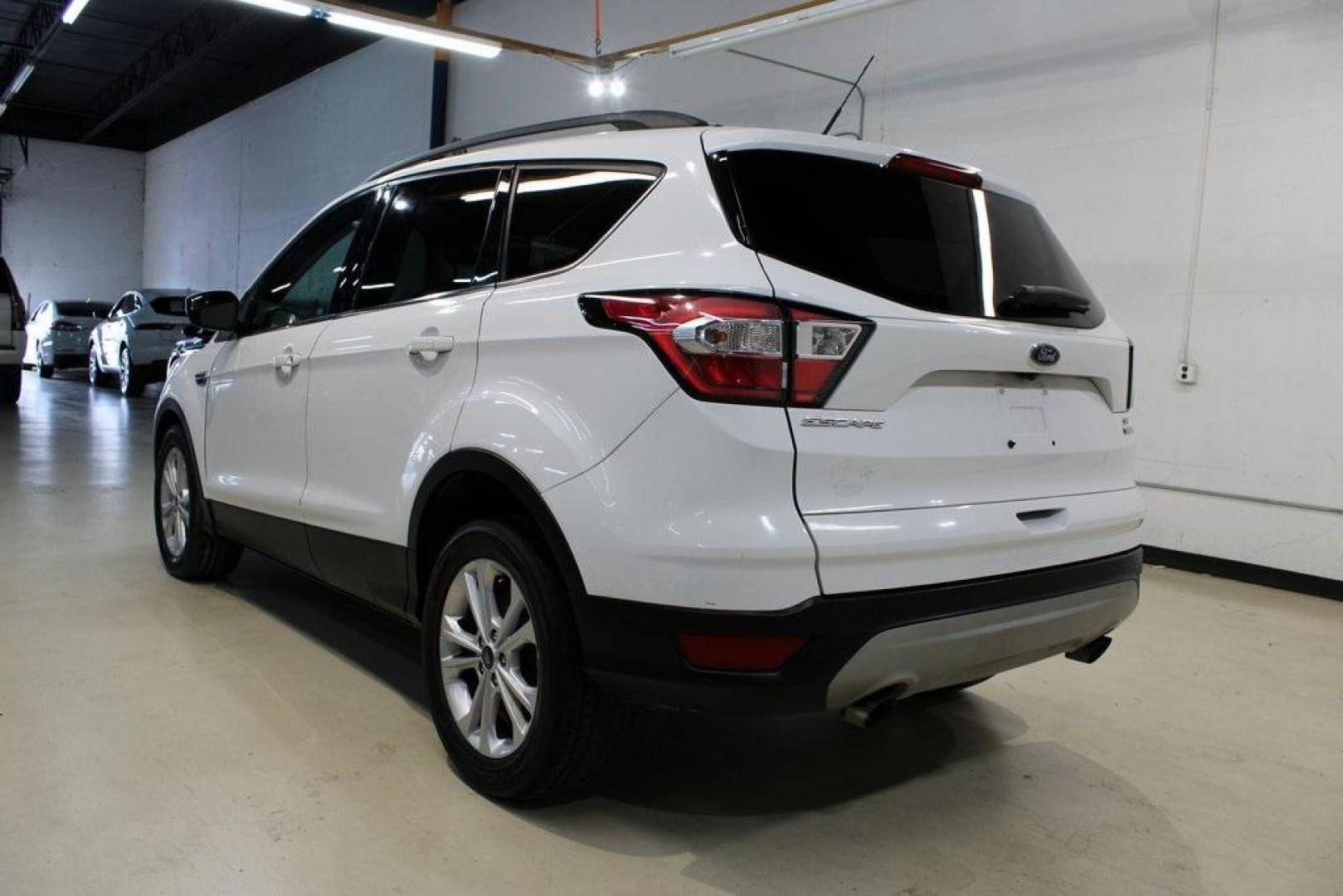 2018 Oxford White /Medium Light Stone Ford Escape SE (1FMCU0G99JU) with an EcoBoost 1.5L I4 GTDi DOHC Turbocharged VCT engine, Automatic transmission, located at 15300 Midway Rd., Addison, TX, 75001, (972) 702-0011, 32.958321, -96.838074 - 2018 Ford Escape SE<br>Now Available at Midway Auto Group Addison, Texas<br><br>The 2018 Ford Escape SE blends sporty style with everyday practicality, making it a top pick for drivers who want comfort, technology, and versatility in a compact SUV. With a turbocharged engine, spacious interior, and - Photo#3