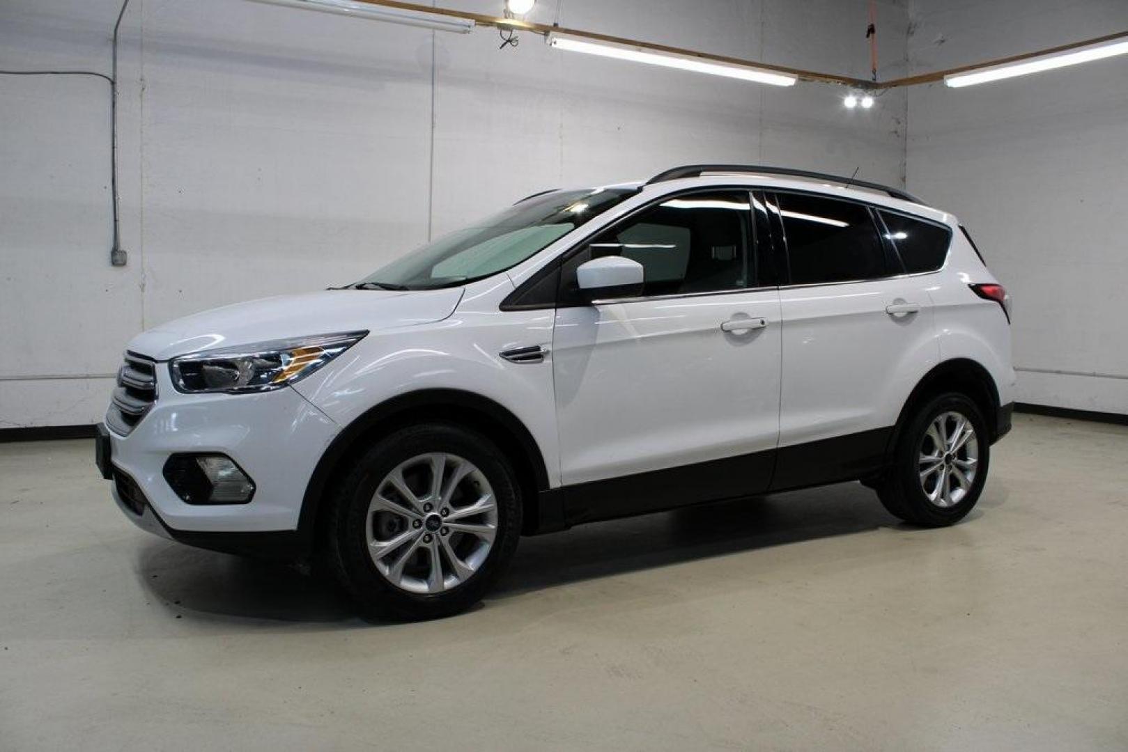 2018 Oxford White /Medium Light Stone Ford Escape SE (1FMCU0G99JU) with an EcoBoost 1.5L I4 GTDi DOHC Turbocharged VCT engine, Automatic transmission, located at 15300 Midway Rd., Addison, TX, 75001, (972) 702-0011, 32.958321, -96.838074 - 2018 Ford Escape SE<br>Now Available at Midway Auto Group Addison, Texas<br><br>The 2018 Ford Escape SE blends sporty style with everyday practicality, making it a top pick for drivers who want comfort, technology, and versatility in a compact SUV. With a turbocharged engine, spacious interior, and - Photo#4
