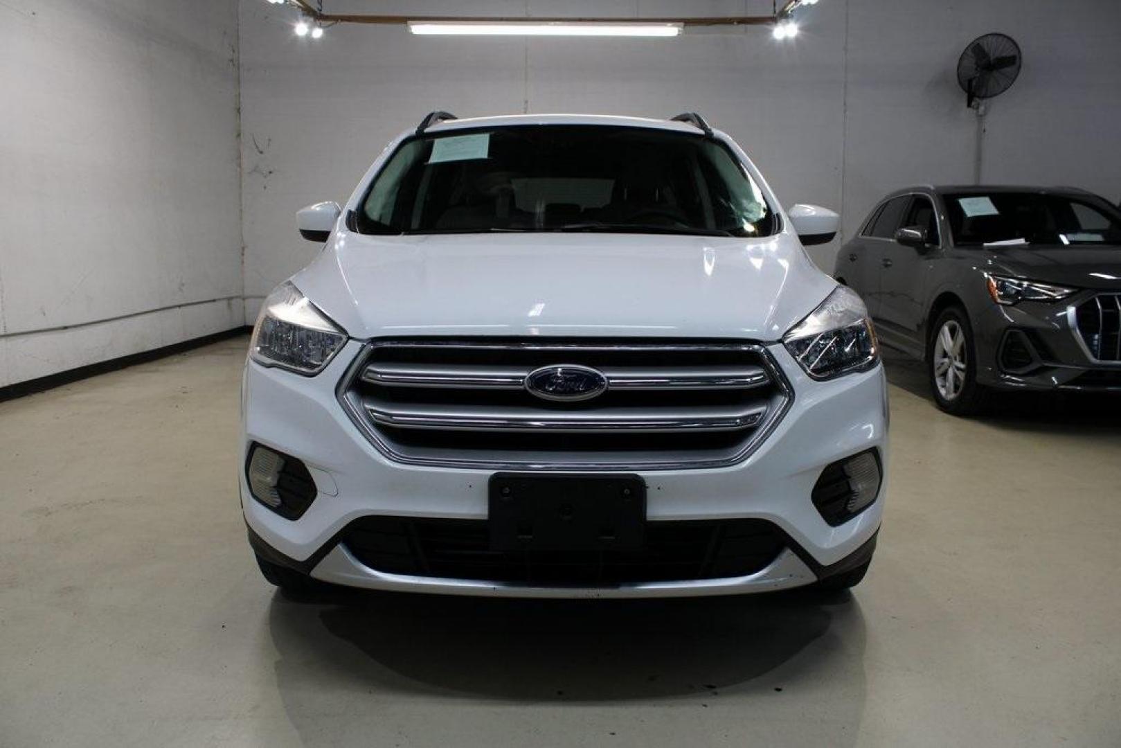 2018 Oxford White /Medium Light Stone Ford Escape SE (1FMCU0G99JU) with an EcoBoost 1.5L I4 GTDi DOHC Turbocharged VCT engine, Automatic transmission, located at 15300 Midway Rd., Addison, TX, 75001, (972) 702-0011, 32.958321, -96.838074 - 2018 Ford Escape SE<br>Now Available at Midway Auto Group Addison, Texas<br><br>The 2018 Ford Escape SE blends sporty style with everyday practicality, making it a top pick for drivers who want comfort, technology, and versatility in a compact SUV. With a turbocharged engine, spacious interior, and - Photo#5