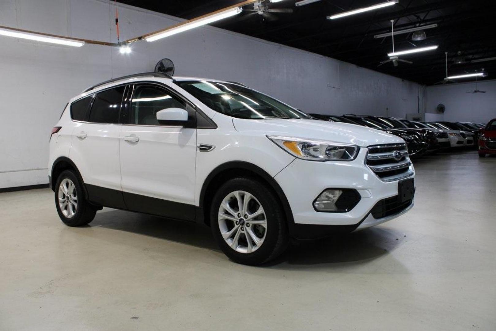 2018 Oxford White /Medium Light Stone Ford Escape SE (1FMCU0G99JU) with an EcoBoost 1.5L I4 GTDi DOHC Turbocharged VCT engine, Automatic transmission, located at 15300 Midway Rd., Addison, TX, 75001, (972) 702-0011, 32.958321, -96.838074 - 2018 Ford Escape SE<br>Now Available at Midway Auto Group Addison, Texas<br><br>The 2018 Ford Escape SE blends sporty style with everyday practicality, making it a top pick for drivers who want comfort, technology, and versatility in a compact SUV. With a turbocharged engine, spacious interior, and - Photo#6
