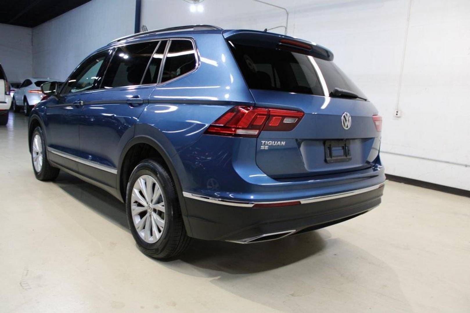 2018 Blue Metallic /Titan Black Volkswagen Tiguan 2.0T SE (3VV3B7AX7JM) with an 2.0L TSI DOHC engine, Automatic transmission, located at 15300 Midway Rd., Addison, TX, 75001, (972) 702-0011, 32.958321, -96.838074 - Photo#2
