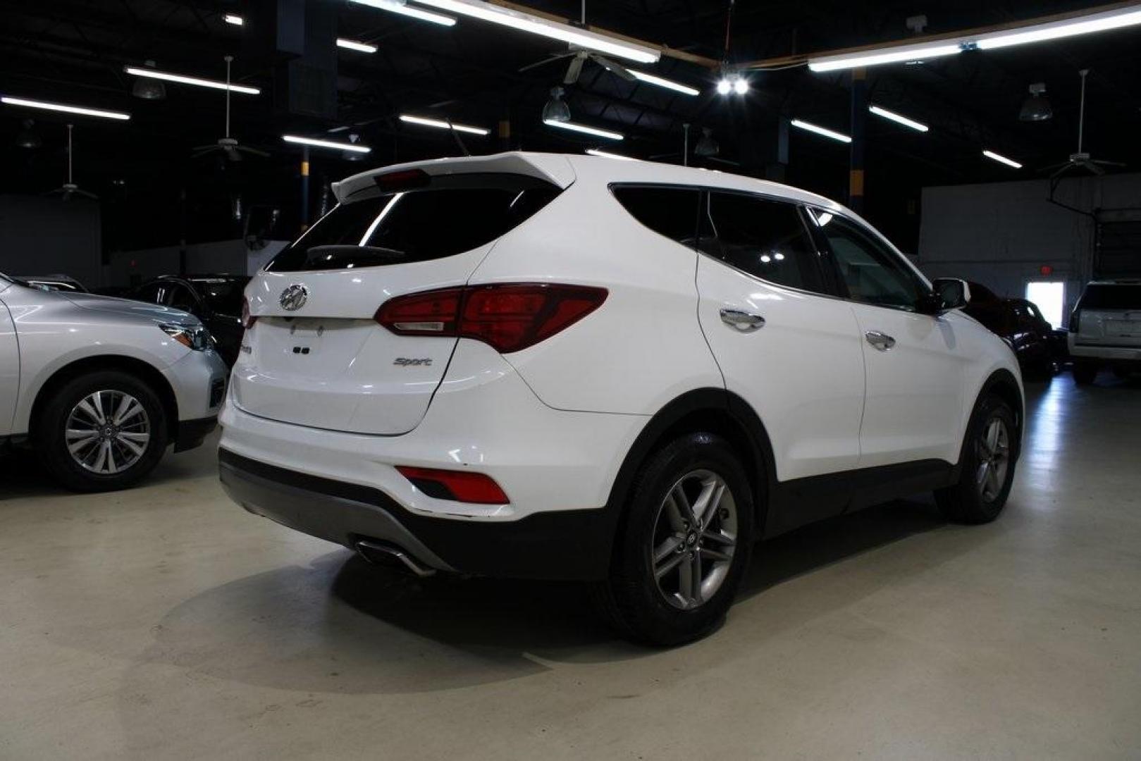 2018 Pearl White /Gray Hyundai Santa Fe Sport 2.4 Base (5XYZT3LB5JG) with an 2.4L I4 DGI DOHC 16V engine, Automatic transmission, located at 15300 Midway Rd., Addison, TX, 75001, (972) 702-0011, 32.958321, -96.838074 - 2018 Hyundai Santa Fe Sport<br>Now Available at Midway Auto Group Addison, Texas<br><br>Spacious, stylish, and versatile, the 2018 Hyundai Santa Fe Sport is a midsize SUV designed to handle daily commutes, weekend getaways, and everything in between. With a comfortable cabin, modern technology, and - Photo#2