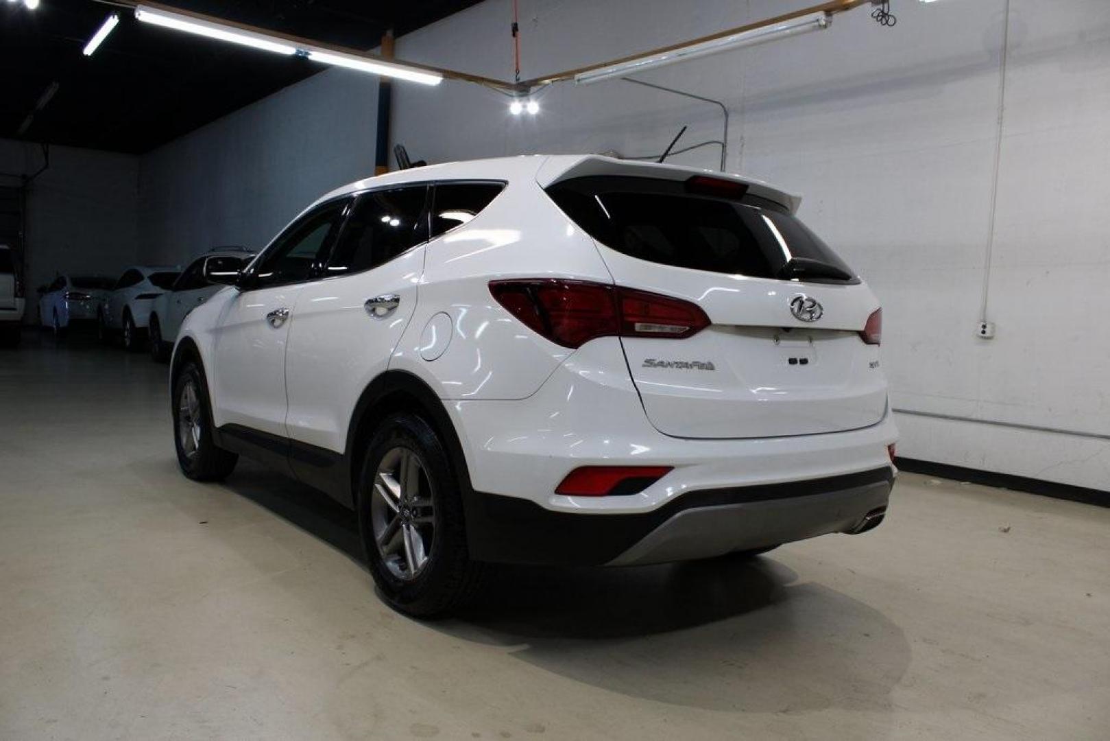 2018 Pearl White /Gray Hyundai Santa Fe Sport 2.4 Base (5XYZT3LB5JG) with an 2.4L I4 DGI DOHC 16V engine, Automatic transmission, located at 15300 Midway Rd., Addison, TX, 75001, (972) 702-0011, 32.958321, -96.838074 - 2018 Hyundai Santa Fe Sport<br>Now Available at Midway Auto Group Addison, Texas<br><br>Spacious, stylish, and versatile, the 2018 Hyundai Santa Fe Sport is a midsize SUV designed to handle daily commutes, weekend getaways, and everything in between. With a comfortable cabin, modern technology, and - Photo#3