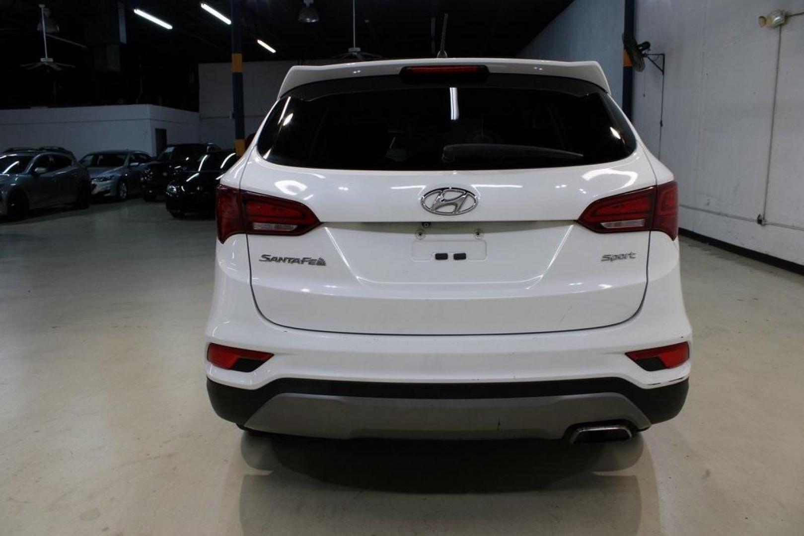 2018 Pearl White /Gray Hyundai Santa Fe Sport 2.4 Base (5XYZT3LB5JG) with an 2.4L I4 DGI DOHC 16V engine, Automatic transmission, located at 15300 Midway Rd., Addison, TX, 75001, (972) 702-0011, 32.958321, -96.838074 - 2018 Hyundai Santa Fe Sport<br>Now Available at Midway Auto Group Addison, Texas<br><br>Spacious, stylish, and versatile, the 2018 Hyundai Santa Fe Sport is a midsize SUV designed to handle daily commutes, weekend getaways, and everything in between. With a comfortable cabin, modern technology, and - Photo#7