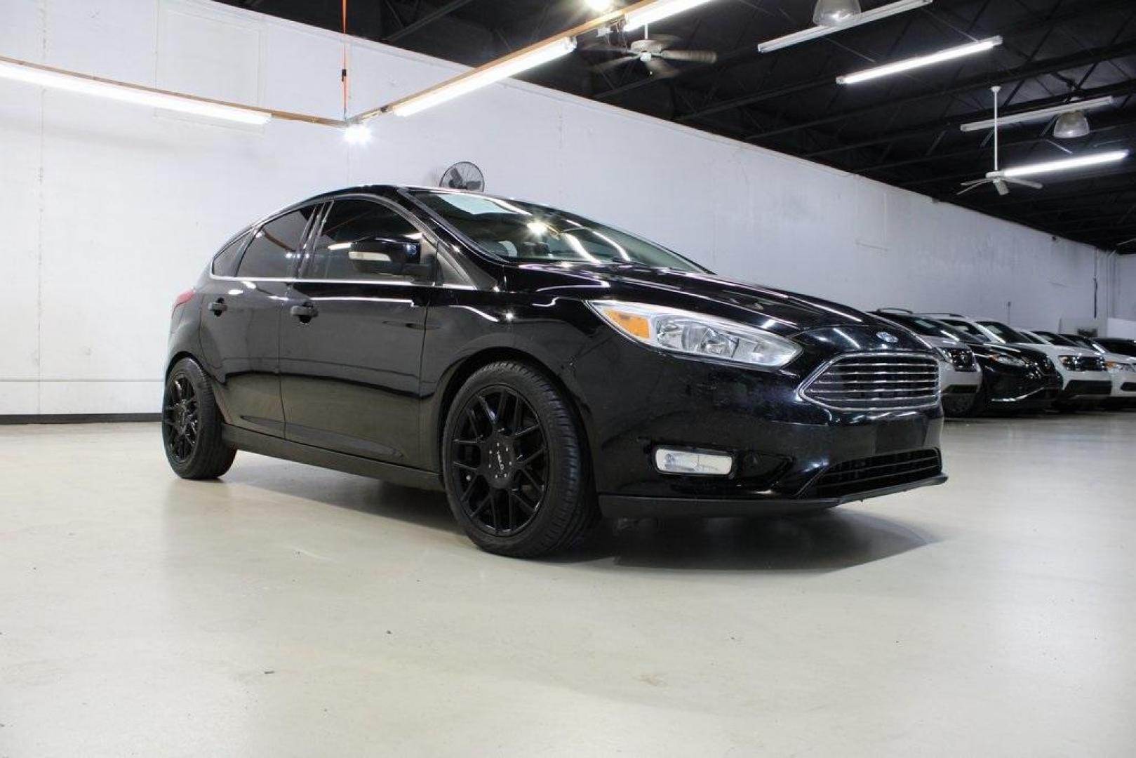 2018 Shadow Black /Medium Soft Ceramic Ford Focus Titanium (1FADP3N21JL) with an 2.0L I4 DGI Ti-VCT engine, Automatic transmission, located at 15300 Midway Rd., Addison, TX, 75001, (972) 702-0011, 32.958321, -96.838074 - HOME OF THE NO HAGGLE PRICE - WHOLESALE PRICES TO THE PUBLIC!!<br><br>Shadow Black 2018 Ford Focus Titanium<br><br>24/34 City/Highway MPG<br><br>Awards:<br> * 2018 KBB.com 10 Most Awarded Brands * 2018 KBB.com Brand Image Awards<br><br>At Midway Auto Group, we strive to provide you with the best - Photo#1