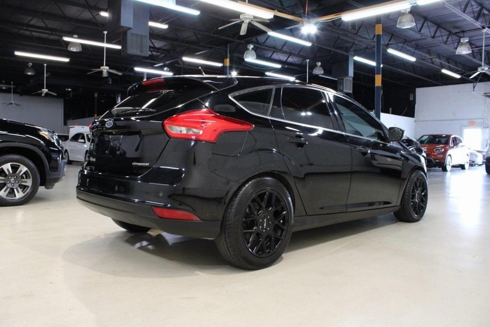 2018 Shadow Black /Medium Soft Ceramic Ford Focus Titanium (1FADP3N21JL) with an 2.0L I4 DGI Ti-VCT engine, Automatic transmission, located at 15300 Midway Rd., Addison, TX, 75001, (972) 702-0011, 32.958321, -96.838074 - HOME OF THE NO HAGGLE PRICE - WHOLESALE PRICES TO THE PUBLIC!!<br><br>Shadow Black 2018 Ford Focus Titanium<br><br>24/34 City/Highway MPG<br><br>Awards:<br> * 2018 KBB.com 10 Most Awarded Brands * 2018 KBB.com Brand Image Awards<br><br>At Midway Auto Group, we strive to provide you with the best - Photo#2