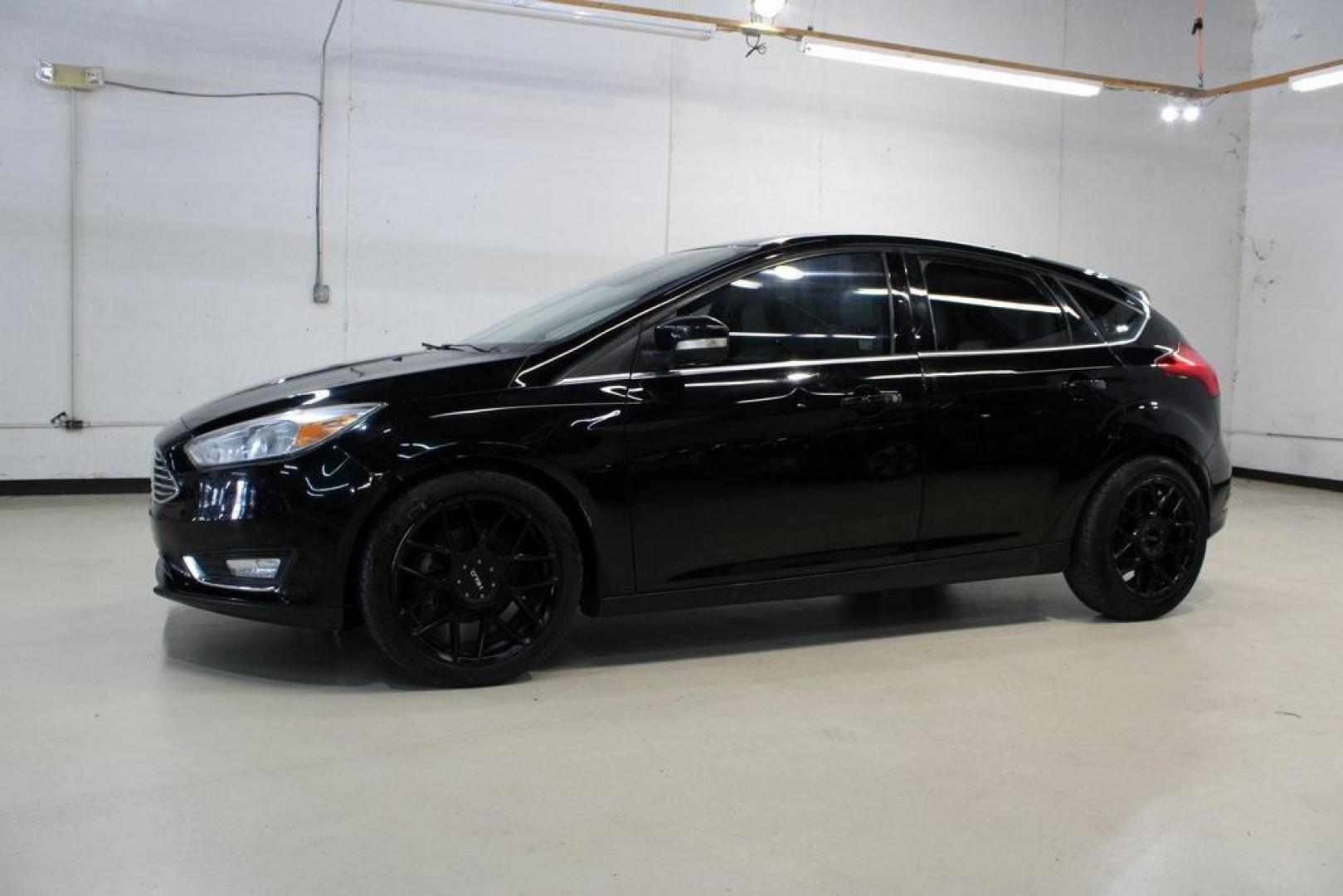 2018 Shadow Black /Medium Soft Ceramic Ford Focus Titanium (1FADP3N21JL) with an 2.0L I4 DGI Ti-VCT engine, Automatic transmission, located at 15300 Midway Rd., Addison, TX, 75001, (972) 702-0011, 32.958321, -96.838074 - HOME OF THE NO HAGGLE PRICE - WHOLESALE PRICES TO THE PUBLIC!!<br><br>Shadow Black 2018 Ford Focus Titanium<br><br>24/34 City/Highway MPG<br><br>Awards:<br> * 2018 KBB.com 10 Most Awarded Brands * 2018 KBB.com Brand Image Awards<br><br>At Midway Auto Group, we strive to provide you with the best - Photo#4
