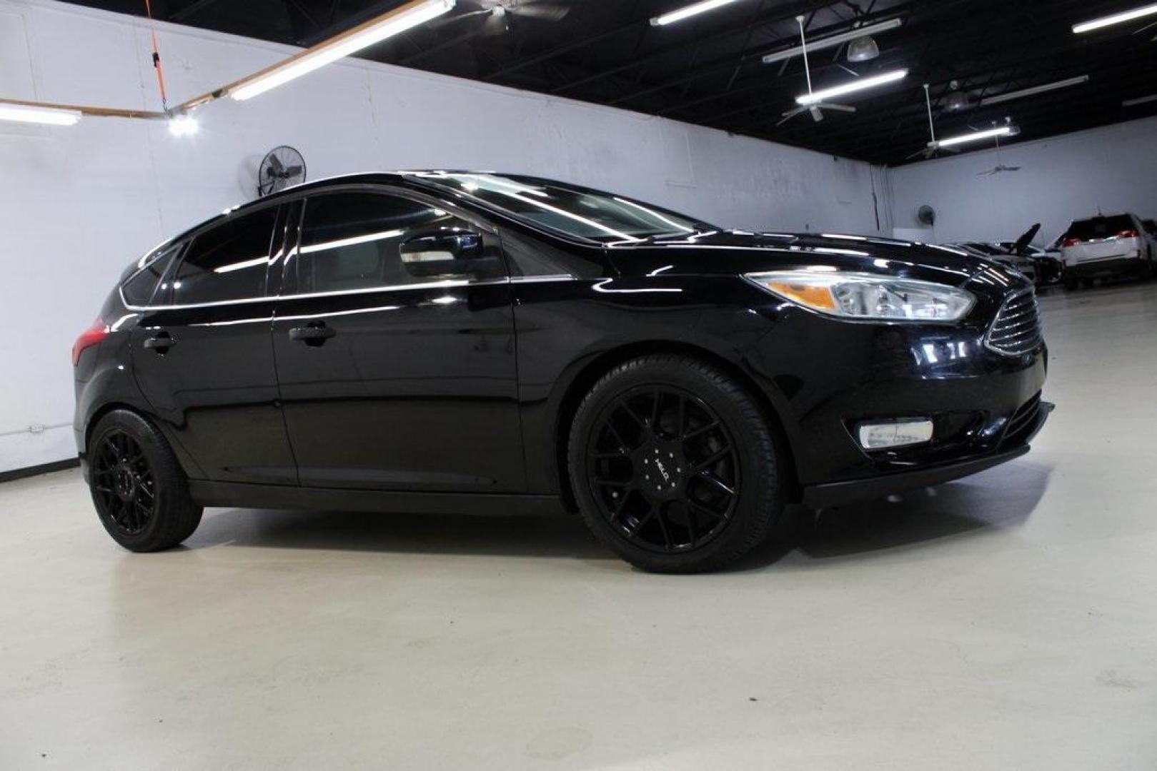 2018 Shadow Black /Medium Soft Ceramic Ford Focus Titanium (1FADP3N21JL) with an 2.0L I4 DGI Ti-VCT engine, Automatic transmission, located at 15300 Midway Rd., Addison, TX, 75001, (972) 702-0011, 32.958321, -96.838074 - HOME OF THE NO HAGGLE PRICE - WHOLESALE PRICES TO THE PUBLIC!!<br><br>Shadow Black 2018 Ford Focus Titanium<br><br>24/34 City/Highway MPG<br><br>Awards:<br> * 2018 KBB.com 10 Most Awarded Brands * 2018 KBB.com Brand Image Awards<br><br>At Midway Auto Group, we strive to provide you with the best - Photo#6