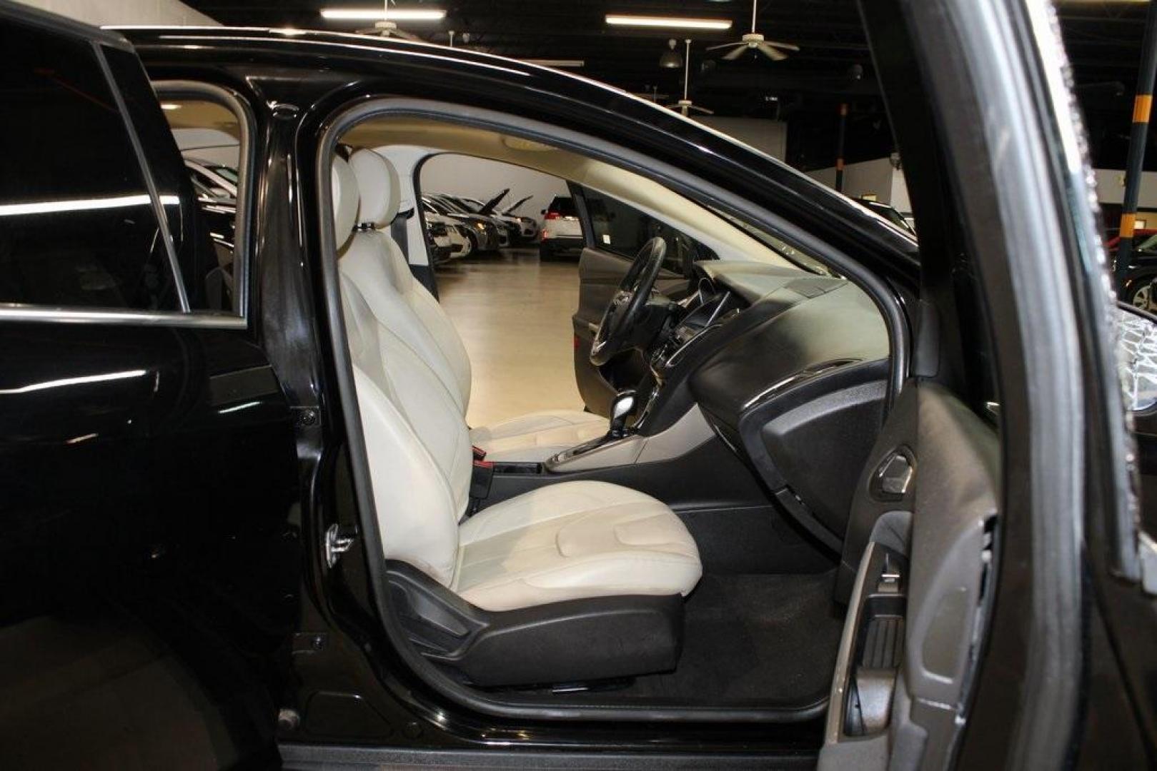 2018 Shadow Black /Medium Soft Ceramic Ford Focus Titanium (1FADP3N21JL) with an 2.0L I4 DGI Ti-VCT engine, Automatic transmission, located at 15300 Midway Rd., Addison, TX, 75001, (972) 702-0011, 32.958321, -96.838074 - HOME OF THE NO HAGGLE PRICE - WHOLESALE PRICES TO THE PUBLIC!!<br><br>Shadow Black 2018 Ford Focus Titanium<br><br>24/34 City/Highway MPG<br><br>Awards:<br> * 2018 KBB.com 10 Most Awarded Brands * 2018 KBB.com Brand Image Awards<br><br>At Midway Auto Group, we strive to provide you with the best - Photo#14