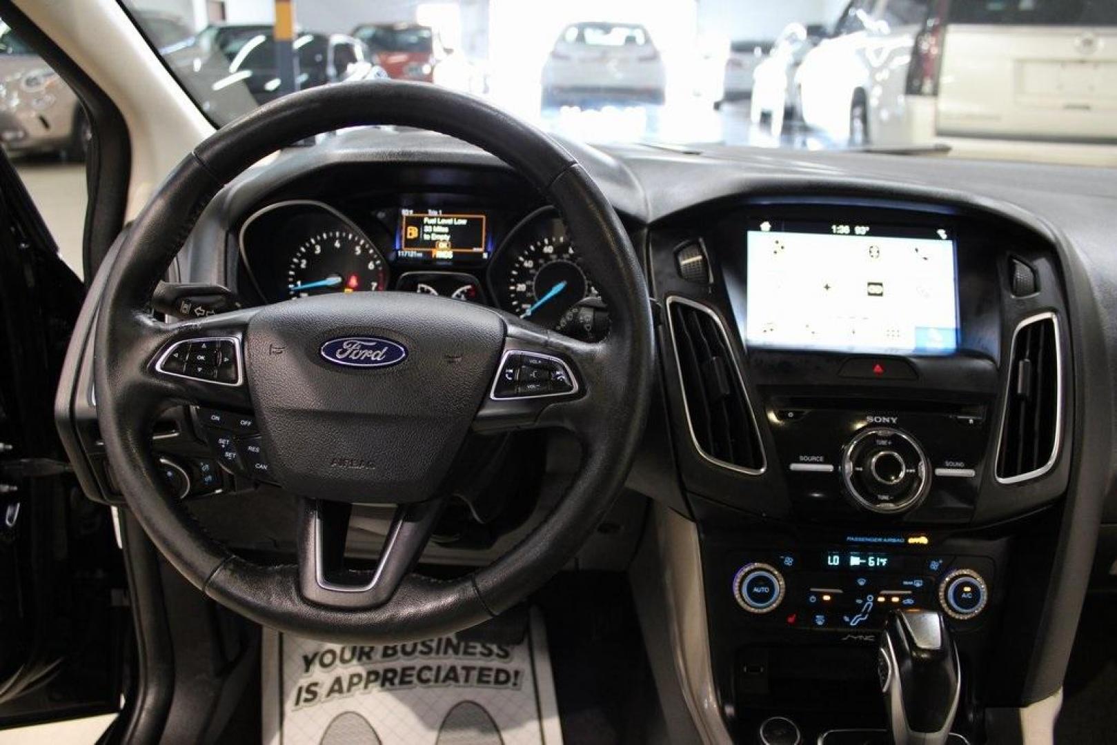 2018 Shadow Black /Medium Soft Ceramic Ford Focus Titanium (1FADP3N21JL) with an 2.0L I4 DGI Ti-VCT engine, Automatic transmission, located at 15300 Midway Rd., Addison, TX, 75001, (972) 702-0011, 32.958321, -96.838074 - HOME OF THE NO HAGGLE PRICE - WHOLESALE PRICES TO THE PUBLIC!!<br><br>Shadow Black 2018 Ford Focus Titanium<br><br>24/34 City/Highway MPG<br><br>Awards:<br> * 2018 KBB.com 10 Most Awarded Brands * 2018 KBB.com Brand Image Awards<br><br>At Midway Auto Group, we strive to provide you with the best - Photo#17