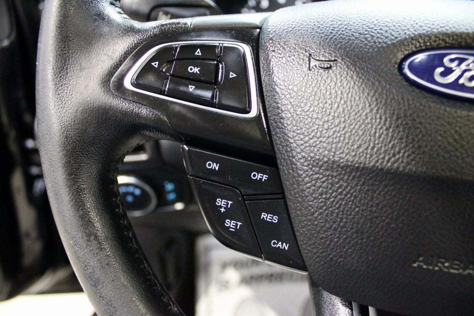 2018 Shadow Black /Medium Soft Ceramic Ford Focus Titanium (1FADP3N21JL) with an 2.0L I4 DGI Ti-VCT engine, Automatic transmission, located at 15300 Midway Rd., Addison, TX, 75001, (972) 702-0011, 32.958321, -96.838074 - HOME OF THE NO HAGGLE PRICE - WHOLESALE PRICES TO THE PUBLIC!!<br><br>Shadow Black 2018 Ford Focus Titanium<br><br>24/34 City/Highway MPG<br><br>Awards:<br> * 2018 KBB.com 10 Most Awarded Brands * 2018 KBB.com Brand Image Awards<br><br>At Midway Auto Group, we strive to provide you with the best - Photo#24