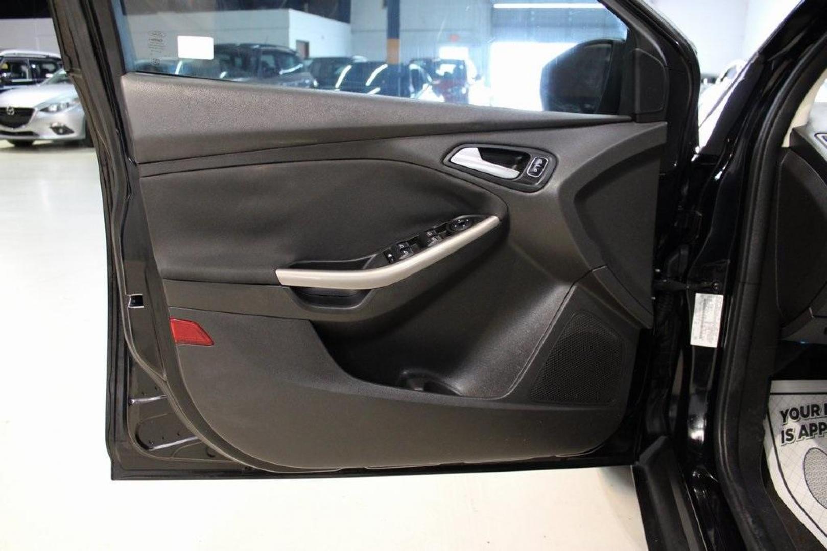 2018 Shadow Black /Medium Soft Ceramic Ford Focus Titanium (1FADP3N21JL) with an 2.0L I4 DGI Ti-VCT engine, Automatic transmission, located at 15300 Midway Rd., Addison, TX, 75001, (972) 702-0011, 32.958321, -96.838074 - HOME OF THE NO HAGGLE PRICE - WHOLESALE PRICES TO THE PUBLIC!!<br><br>Shadow Black 2018 Ford Focus Titanium<br><br>24/34 City/Highway MPG<br><br>Awards:<br> * 2018 KBB.com 10 Most Awarded Brands * 2018 KBB.com Brand Image Awards<br><br>At Midway Auto Group, we strive to provide you with the best - Photo#26