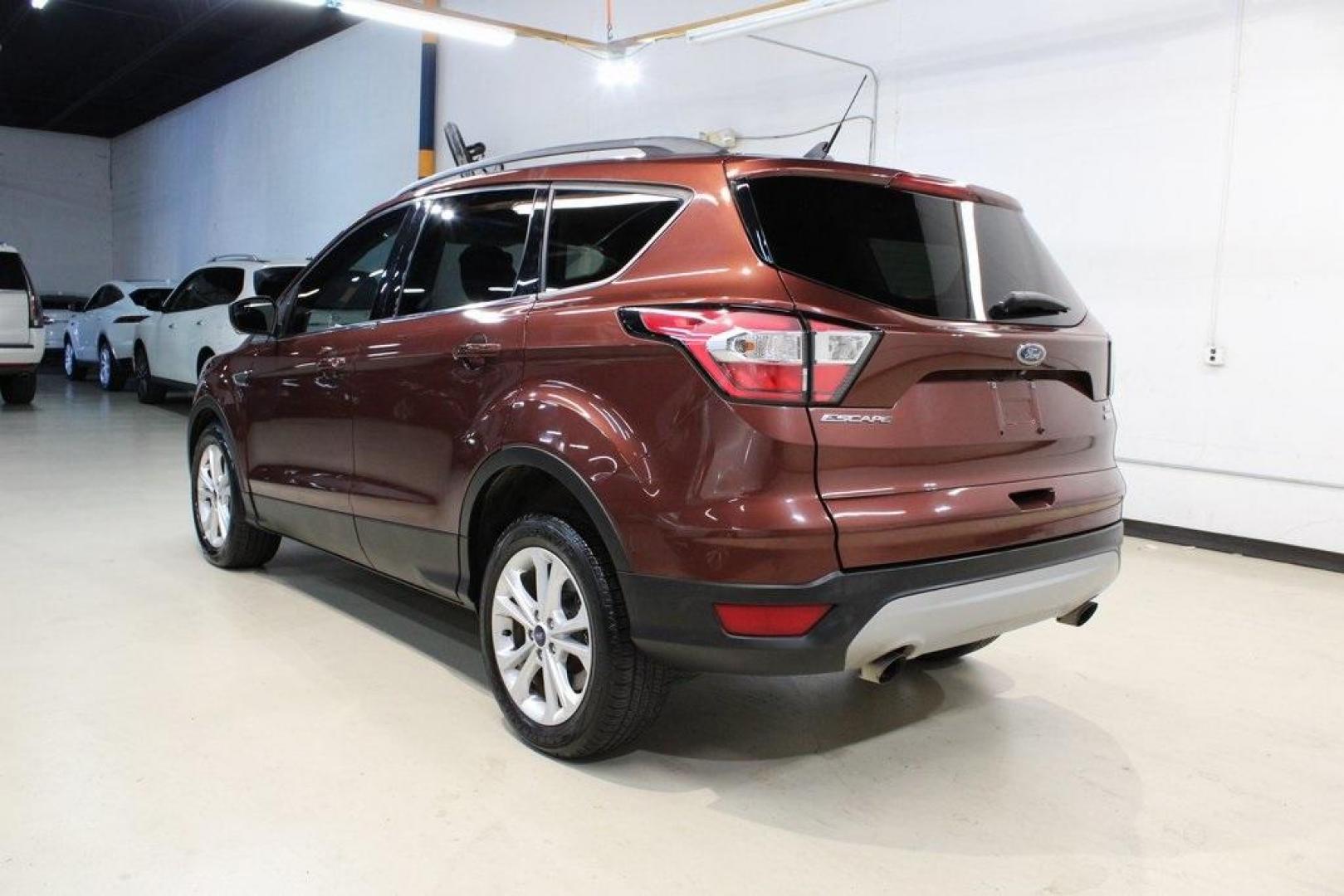 2018 Cinnamon Glaze /Charcoal Black Ford Escape SE (1FMCU0GD6JU) with an EcoBoost 2.0L I4 GTDi DOHC Turbocharged VCT engine, Automatic transmission, located at 15300 Midway Rd., Addison, TX, 75001, (972) 702-0011, 32.958321, -96.838074 - HOME OF THE NO HAGGLE PRICE - WHOLESALE PRICES TO THE PUBLIC!!<br><br>Cinnamon Glaze 2018 Ford Escape SE<br><br>23/30 City/Highway MPG<br><br>Awards:<br> * 2018 KBB.com 10 Most Awarded Brands * 2018 KBB.com Brand Image Awards<br><br>At Midway Auto Group, we strive to provide you with the best qua - Photo#3