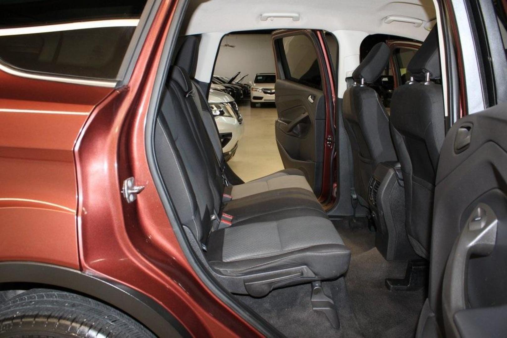 2018 Cinnamon Glaze /Charcoal Black Ford Escape SE (1FMCU0GD6JU) with an EcoBoost 2.0L I4 GTDi DOHC Turbocharged VCT engine, Automatic transmission, located at 15300 Midway Rd., Addison, TX, 75001, (972) 702-0011, 32.958321, -96.838074 - HOME OF THE NO HAGGLE PRICE - WHOLESALE PRICES TO THE PUBLIC!!<br><br>Cinnamon Glaze 2018 Ford Escape SE<br><br>23/30 City/Highway MPG<br><br>Awards:<br> * 2018 KBB.com 10 Most Awarded Brands * 2018 KBB.com Brand Image Awards<br><br>At Midway Auto Group, we strive to provide you with the best qua - Photo#15