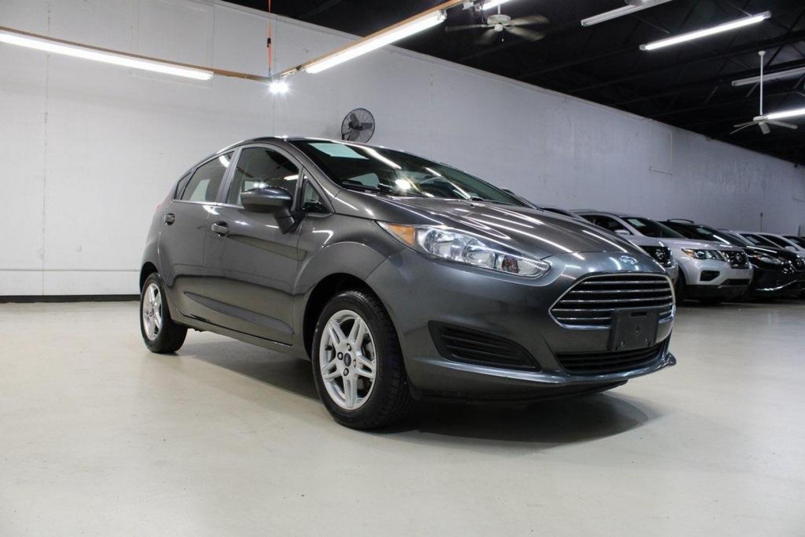 2019 Magnetic /Black Ford Fiesta SE (3FADP4EJ7KM) with an 1.6L I4 Ti-VCT engine, Automatic transmission, located at 15300 Midway Rd., Addison, TX, 75001, (972) 702-0011, 32.958321, -96.838074 - HOME OF THE NO HAGGLE PRICE - WHOLESALE PRICES TO THE PUBLIC!!<br><br>Magnetic 2019 Ford Fiesta SE<br><br>Recent Arrival! 27/37 City/Highway MPG<br><br><br>At Midway Auto Group, we strive to provide you with the best quality vehicles for the lowest possible price, and this 2019 Ford Fiesta is no exc - Photo#1