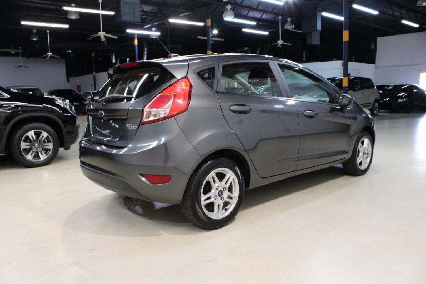 2019 Magnetic /Black Ford Fiesta SE (3FADP4EJ7KM) with an 1.6L I4 Ti-VCT engine, Automatic transmission, located at 15300 Midway Rd., Addison, TX, 75001, (972) 702-0011, 32.958321, -96.838074 - HOME OF THE NO HAGGLE PRICE - WHOLESALE PRICES TO THE PUBLIC!!<br><br>Magnetic 2019 Ford Fiesta SE<br><br>Recent Arrival! 27/37 City/Highway MPG<br><br><br>At Midway Auto Group, we strive to provide you with the best quality vehicles for the lowest possible price, and this 2019 Ford Fiesta is no exc - Photo#2