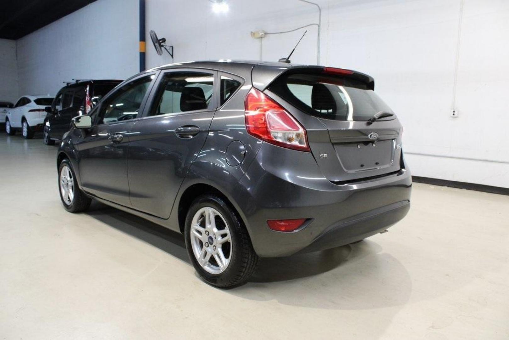 2019 Magnetic /Black Ford Fiesta SE (3FADP4EJ7KM) with an 1.6L I4 Ti-VCT engine, Automatic transmission, located at 15300 Midway Rd., Addison, TX, 75001, (972) 702-0011, 32.958321, -96.838074 - HOME OF THE NO HAGGLE PRICE - WHOLESALE PRICES TO THE PUBLIC!!<br><br>Magnetic 2019 Ford Fiesta SE<br><br>Recent Arrival! 27/37 City/Highway MPG<br><br><br>At Midway Auto Group, we strive to provide you with the best quality vehicles for the lowest possible price, and this 2019 Ford Fiesta is no exc - Photo#3