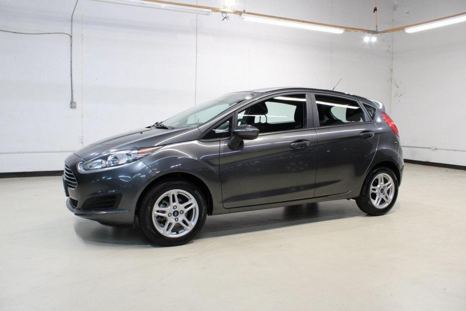 2019 Magnetic /Black Ford Fiesta SE (3FADP4EJ7KM) with an 1.6L I4 Ti-VCT engine, Automatic transmission, located at 15300 Midway Rd., Addison, TX, 75001, (972) 702-0011, 32.958321, -96.838074 - HOME OF THE NO HAGGLE PRICE - WHOLESALE PRICES TO THE PUBLIC!!<br><br>Magnetic 2019 Ford Fiesta SE<br><br>Recent Arrival! 27/37 City/Highway MPG<br><br><br>At Midway Auto Group, we strive to provide you with the best quality vehicles for the lowest possible price, and this 2019 Ford Fiesta is no exc - Photo#4