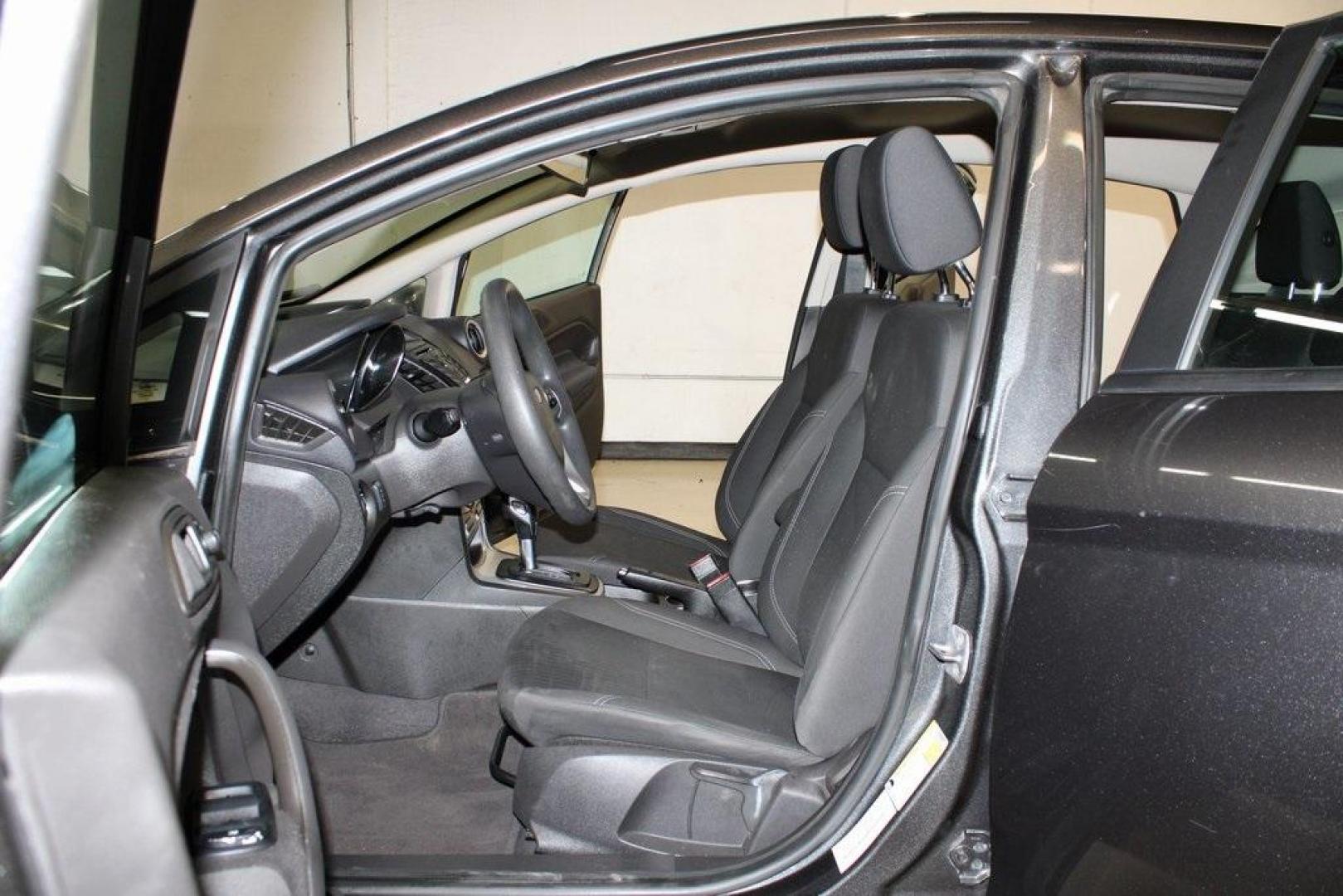 2019 Magnetic /Black Ford Fiesta SE (3FADP4EJ7KM) with an 1.6L I4 Ti-VCT engine, Automatic transmission, located at 15300 Midway Rd., Addison, TX, 75001, (972) 702-0011, 32.958321, -96.838074 - HOME OF THE NO HAGGLE PRICE - WHOLESALE PRICES TO THE PUBLIC!!<br><br>Magnetic 2019 Ford Fiesta SE<br><br>Recent Arrival! 27/37 City/Highway MPG<br><br><br>At Midway Auto Group, we strive to provide you with the best quality vehicles for the lowest possible price, and this 2019 Ford Fiesta is no exc - Photo#12