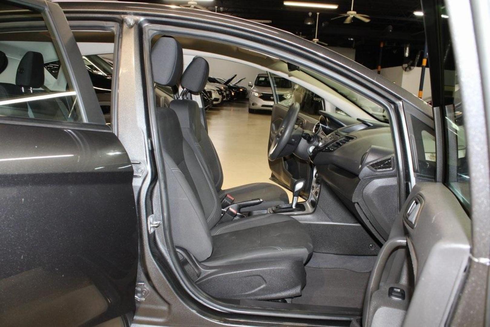 2019 Magnetic /Black Ford Fiesta SE (3FADP4EJ7KM) with an 1.6L I4 Ti-VCT engine, Automatic transmission, located at 15300 Midway Rd., Addison, TX, 75001, (972) 702-0011, 32.958321, -96.838074 - HOME OF THE NO HAGGLE PRICE - WHOLESALE PRICES TO THE PUBLIC!!<br><br>Magnetic 2019 Ford Fiesta SE<br><br>Recent Arrival! 27/37 City/Highway MPG<br><br><br>At Midway Auto Group, we strive to provide you with the best quality vehicles for the lowest possible price, and this 2019 Ford Fiesta is no exc - Photo#13