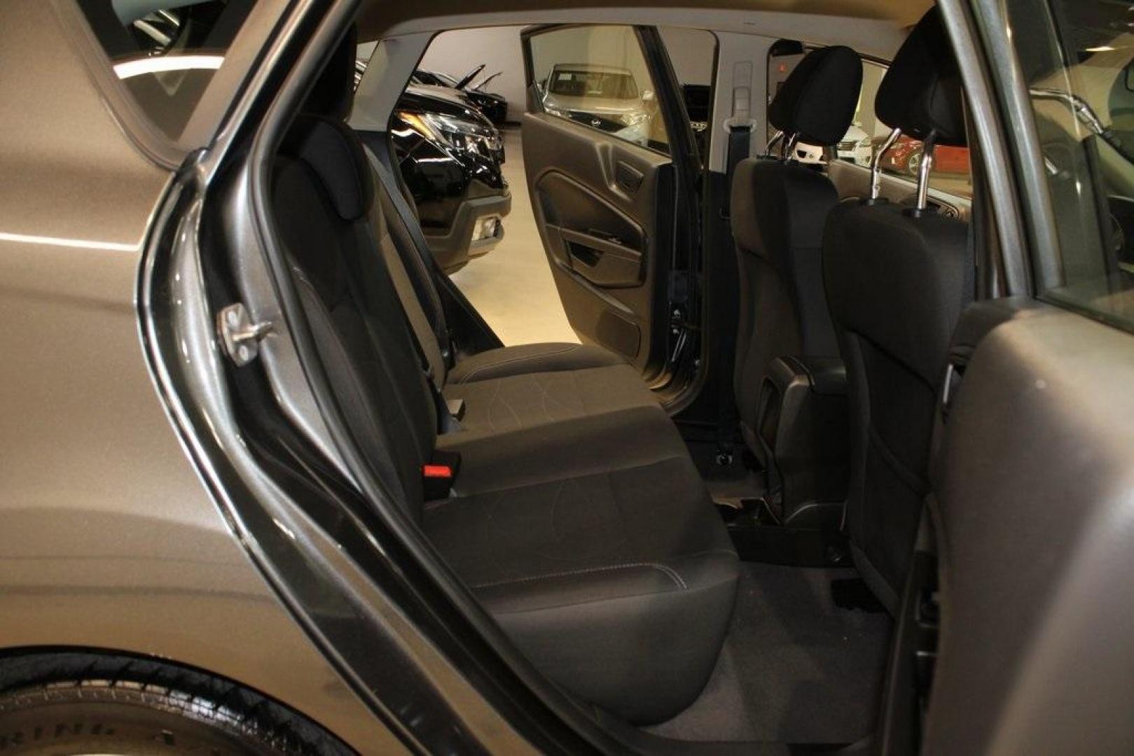 2019 Magnetic /Black Ford Fiesta SE (3FADP4EJ7KM) with an 1.6L I4 Ti-VCT engine, Automatic transmission, located at 15300 Midway Rd., Addison, TX, 75001, (972) 702-0011, 32.958321, -96.838074 - HOME OF THE NO HAGGLE PRICE - WHOLESALE PRICES TO THE PUBLIC!!<br><br>Magnetic 2019 Ford Fiesta SE<br><br>Recent Arrival! 27/37 City/Highway MPG<br><br><br>At Midway Auto Group, we strive to provide you with the best quality vehicles for the lowest possible price, and this 2019 Ford Fiesta is no exc - Photo#14